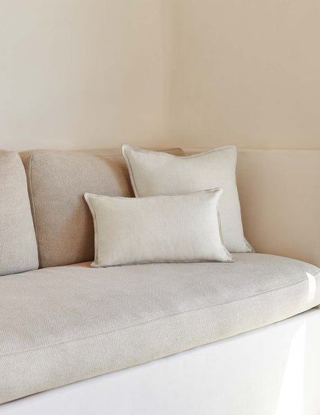 #color::ivory #style::lumbar #fill type::with-feather-down-insert #fill type::pillow-cover-only | The arlo Ivory flax linen pillow in its lumber and square sizes sit together on a natural linen sofa