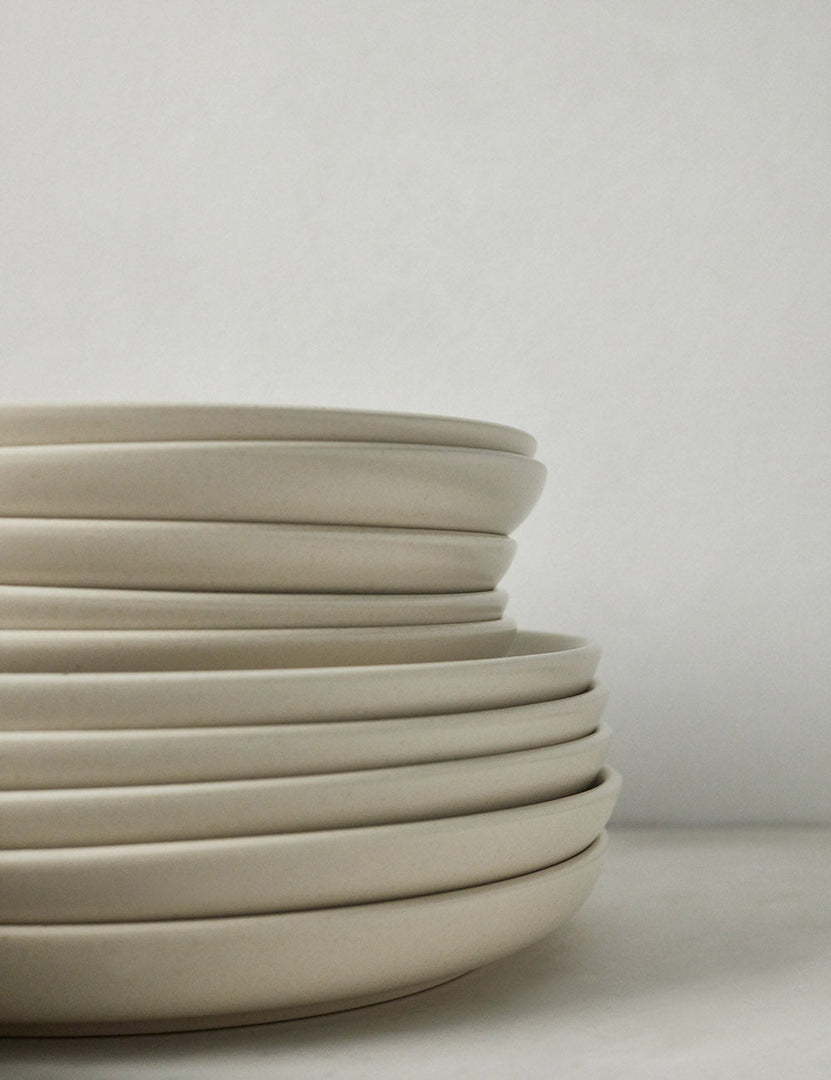 #color::vanilla #style::18-piece-set-with-pasta-bowl | Side view of the plates that are part of the Vanilla-toned Pacifica Dinnerware (18-Piece Set) by Casafina