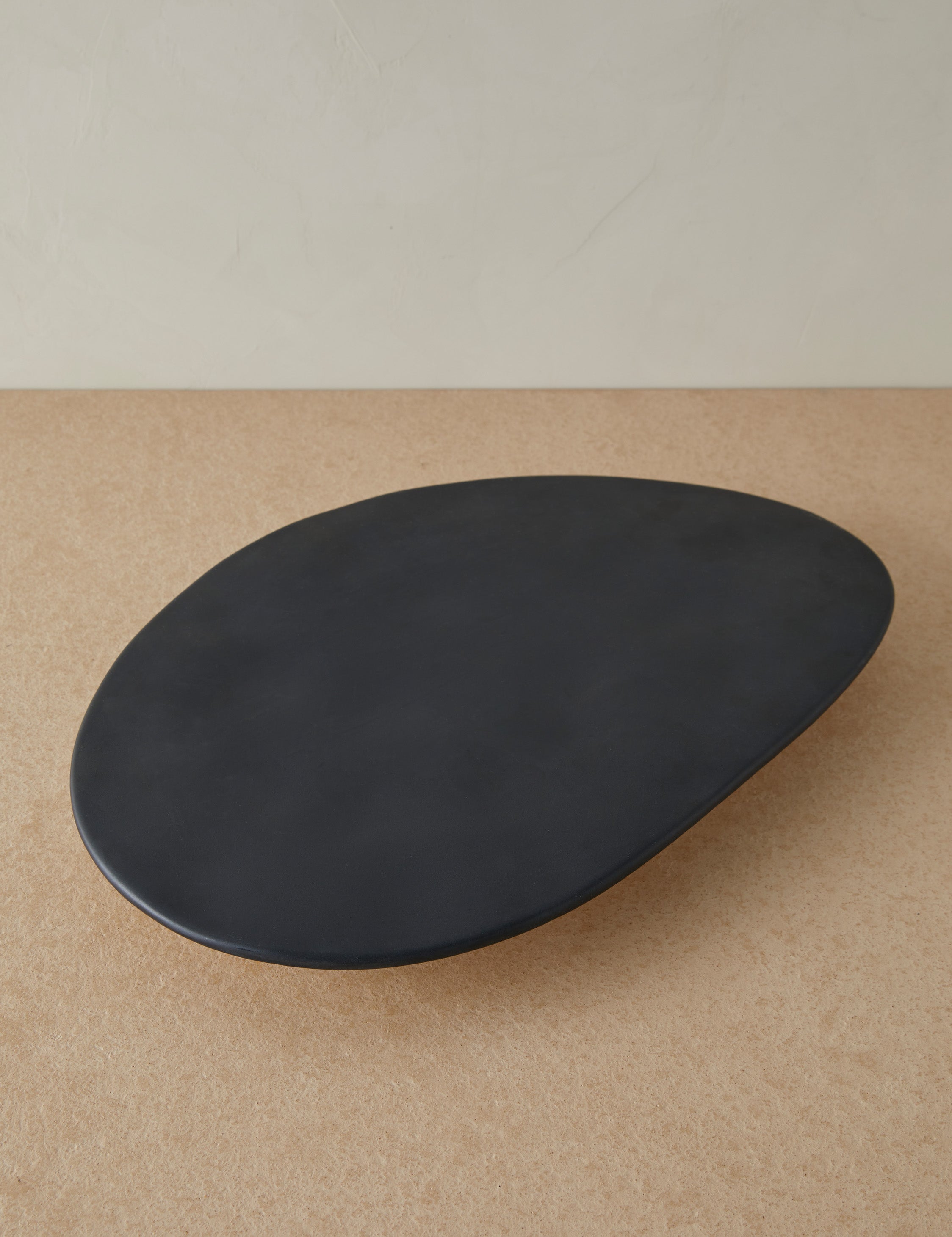 Overhead view of the Footed serving display tray in black