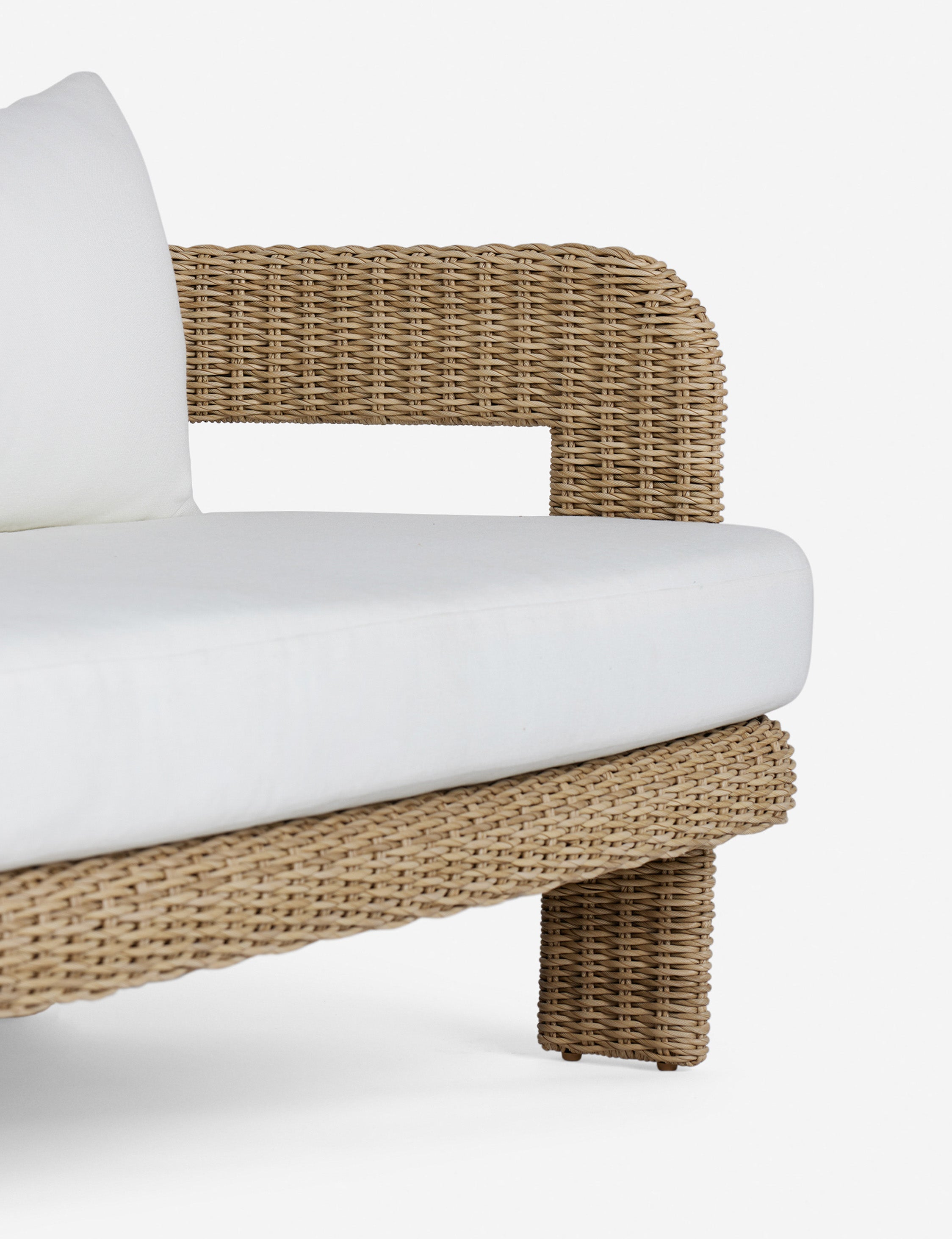 Arm of the Hadler modern sculptural open frame wicker outdoor sofa.