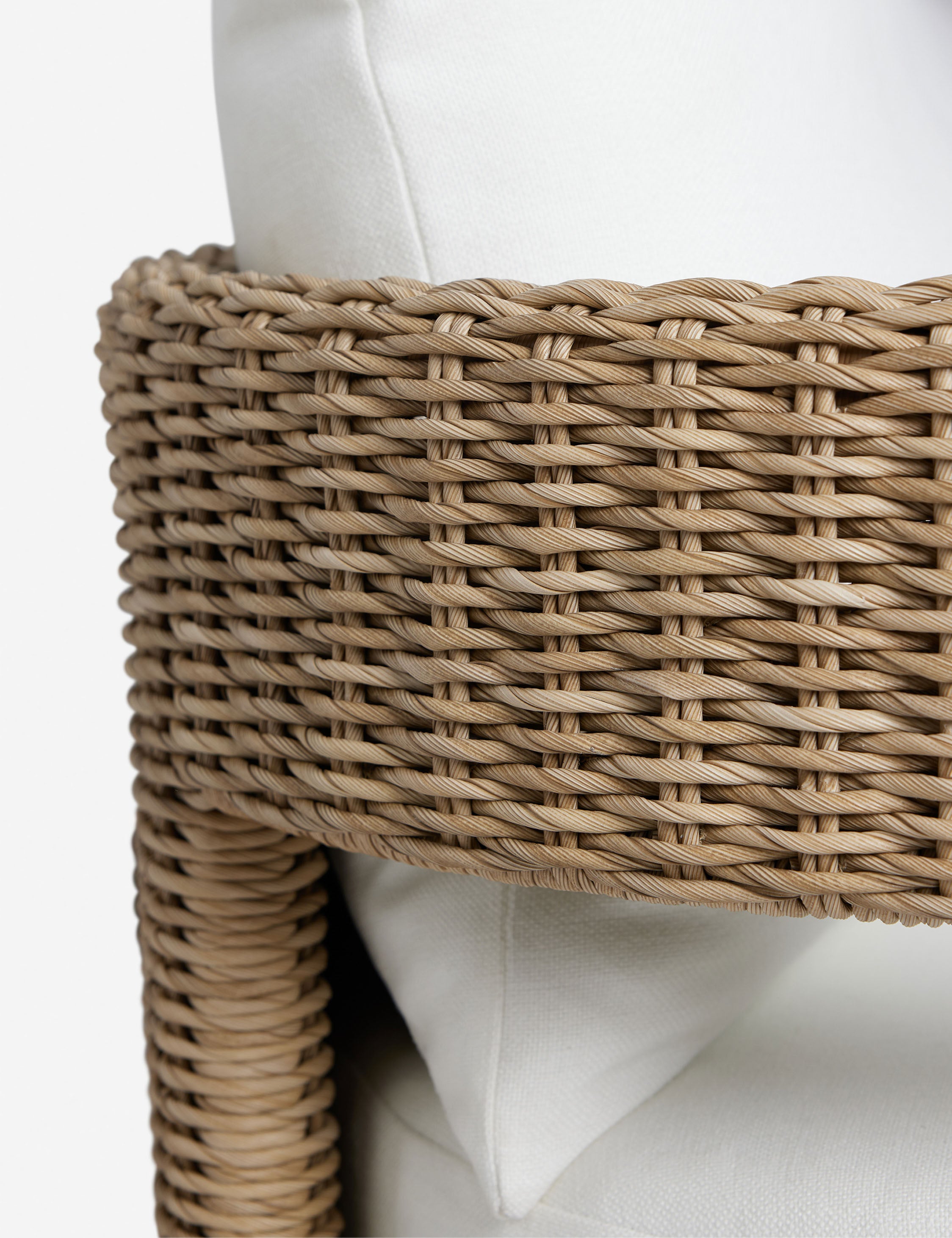 Close up of the Hadler modern sculptural open frame wicker outdoor sofa.