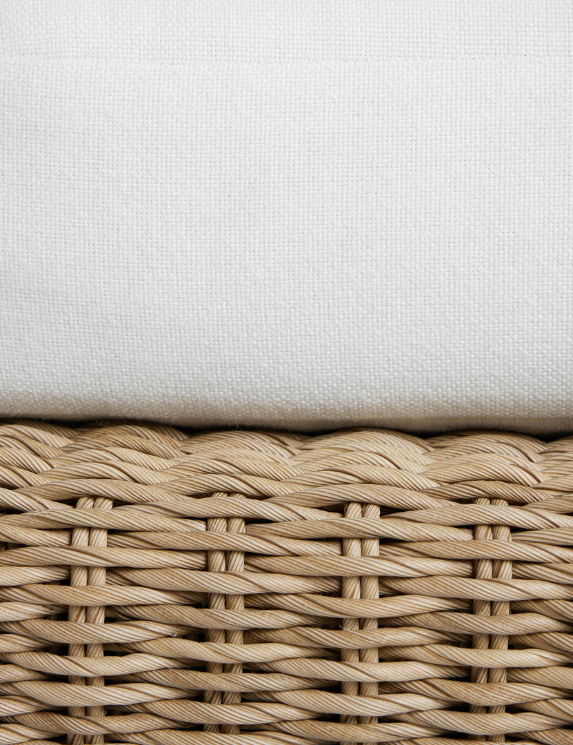 #color::natural | Close up of the seat cushion of the Hadler modern sculptural open frame wicker outdoor sofa.