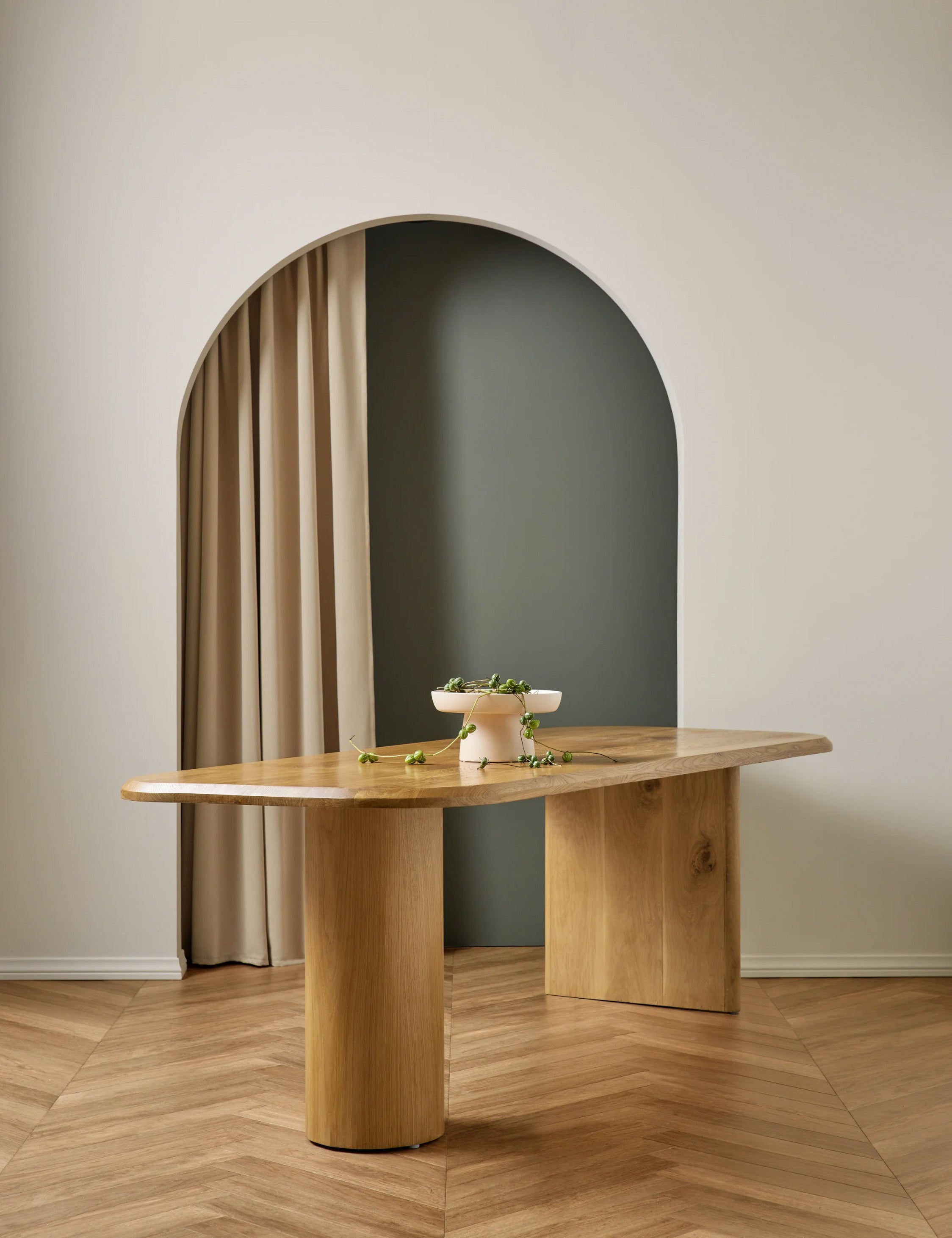 Archer Natural Rectangular Dining Table sits in room with chevron floors and an arched entryway with a cream curtain
