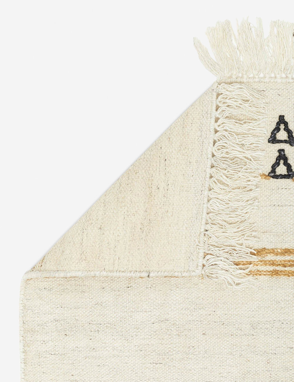 The corner of the Iconic Stripe Rug folded over