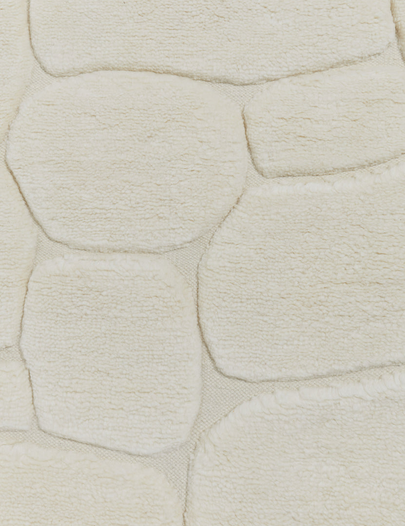 #size::6--x-9- #size::8--x-10- #size::9--x-12- #size::10--x-14- #size::12--x-15- | Close up view of the Kivi raised cobblestone pattern fringe wool area rug