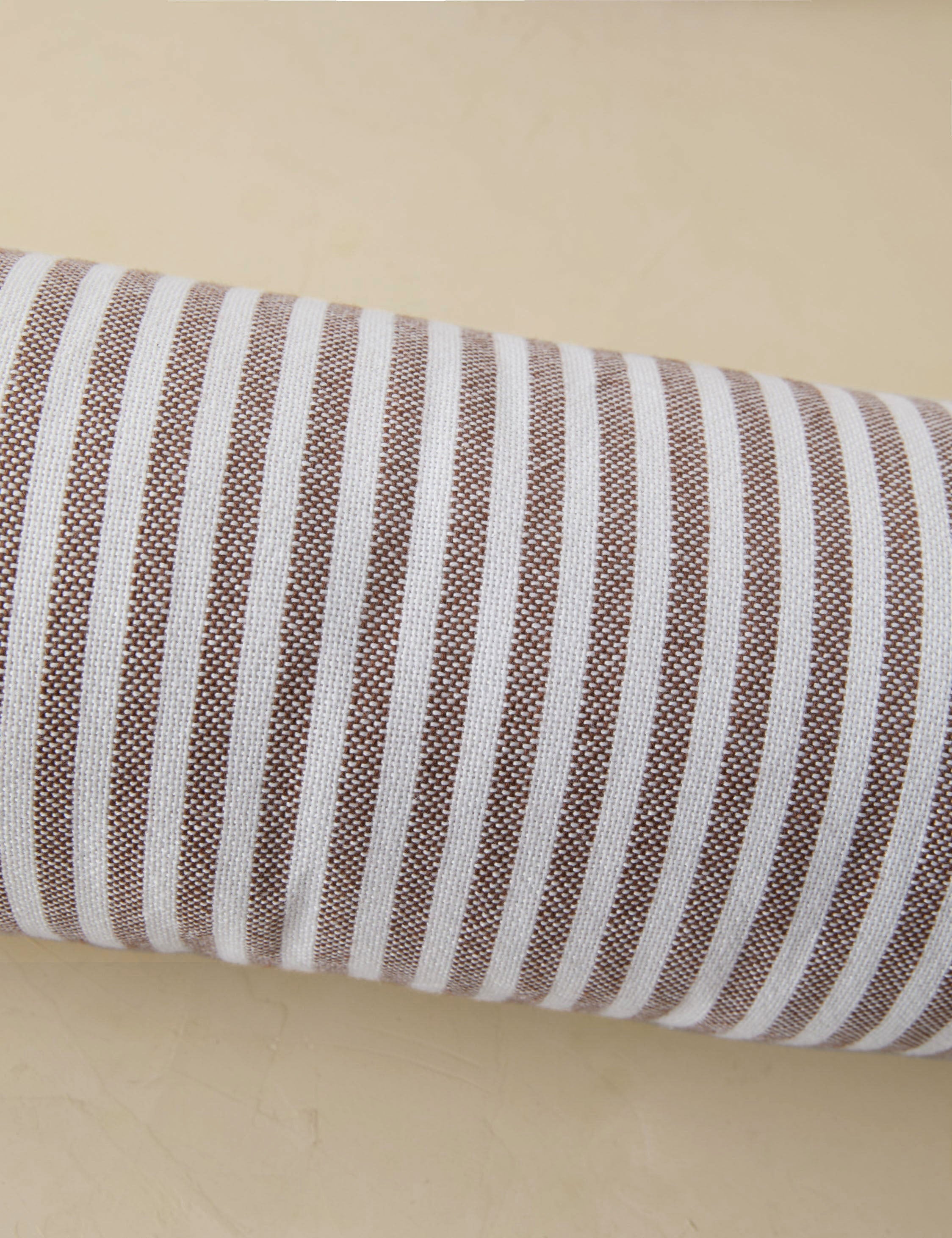 Littu Indoor / Outdoor Striped Bolster Pillow by Sarah Sherman Samuel in Brown