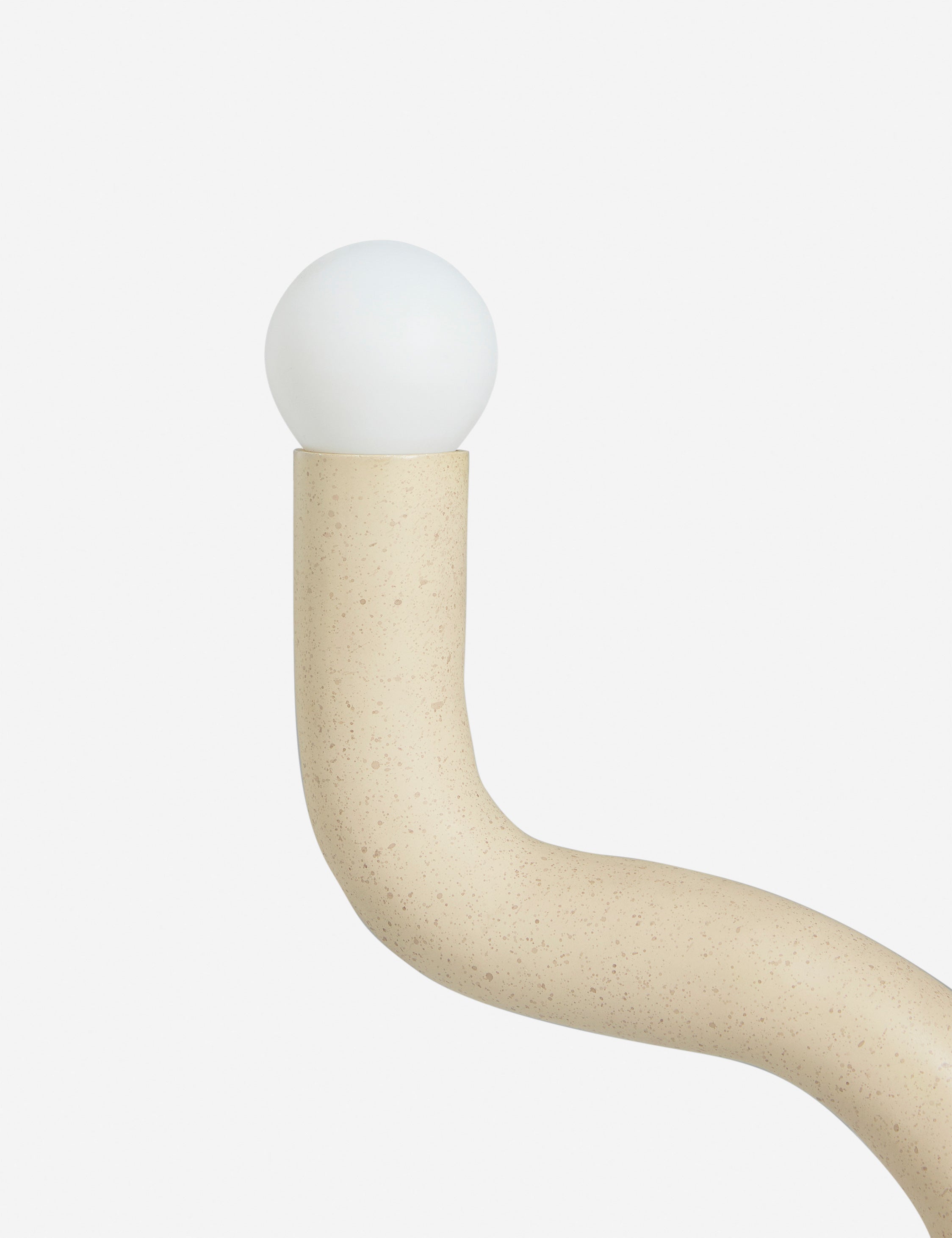 Close up view of the Noor sculptural, wavy table lamp