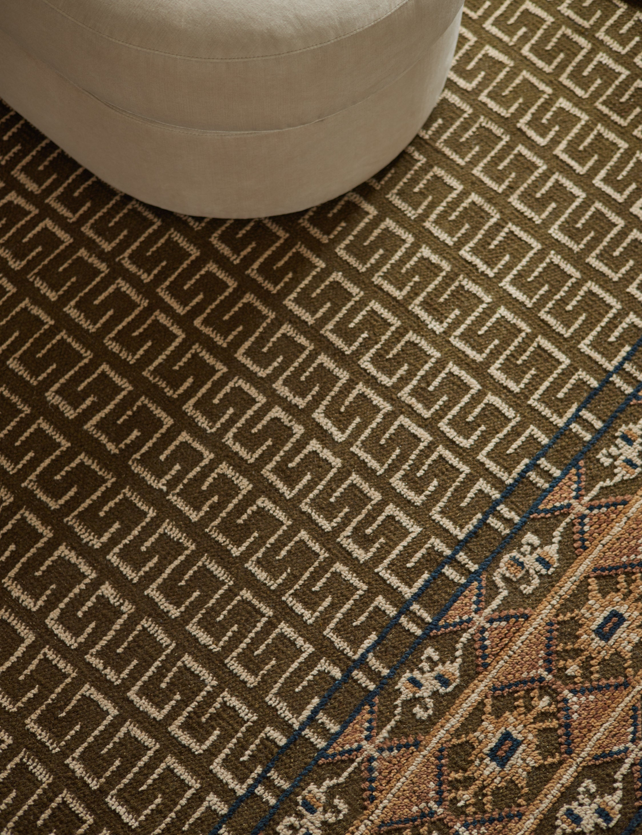 Close up of the Manca traditional geometric motif hand-knotted wool rug.