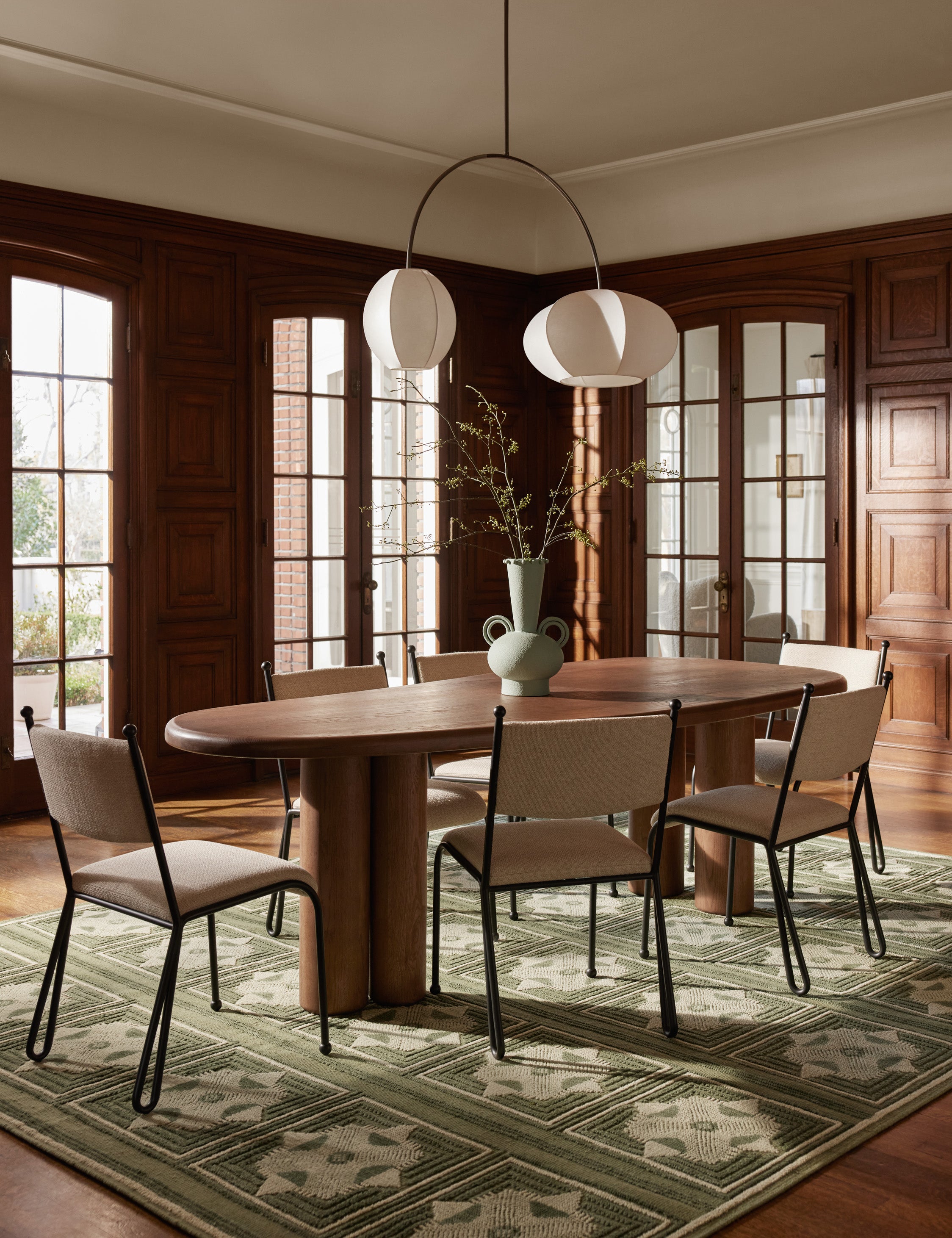 Dining room featuring the Fidia curved metal silhouette dining chair by Aimee Song