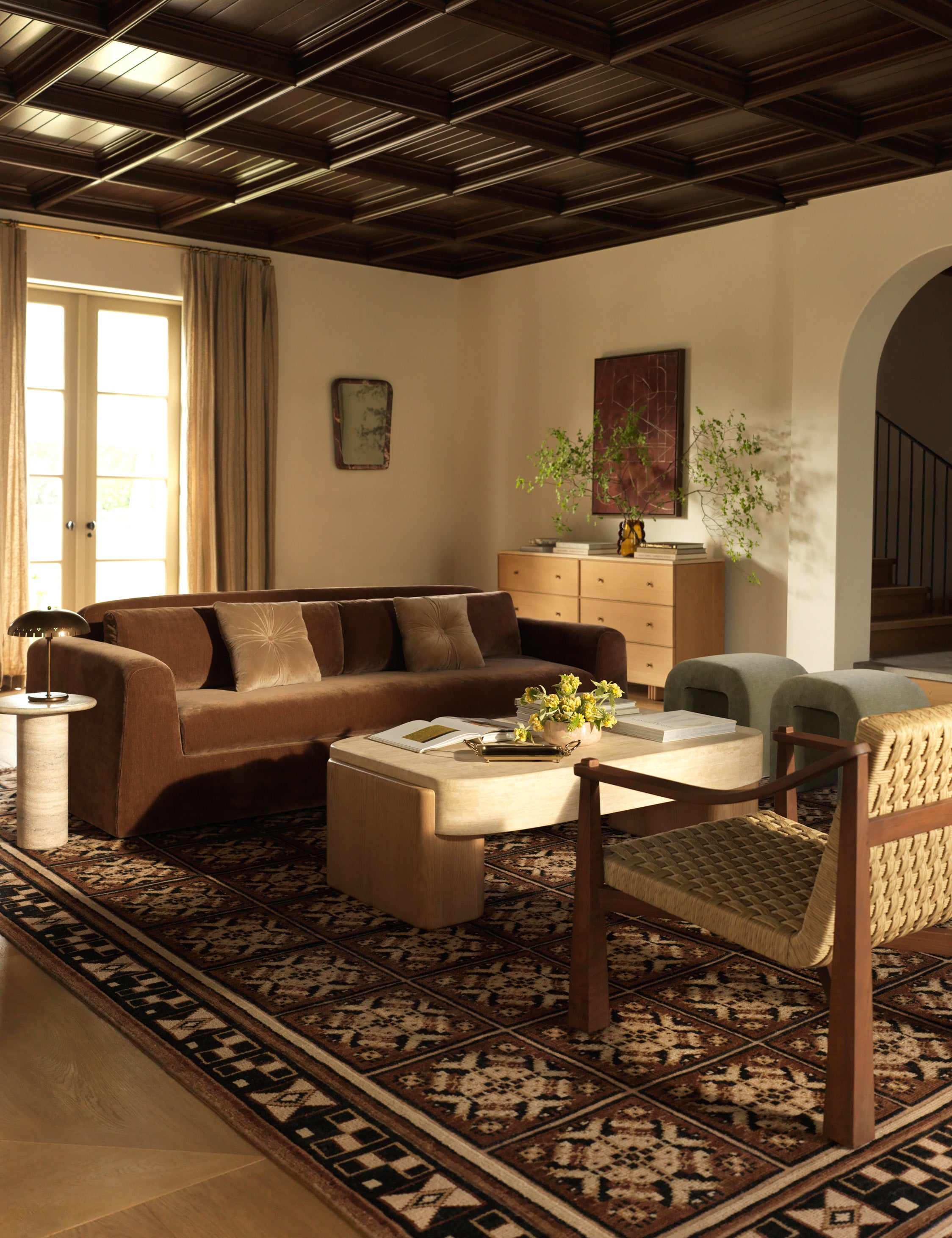 A living room featuring the Ovidi heritage motif hand-knotted wool rug.