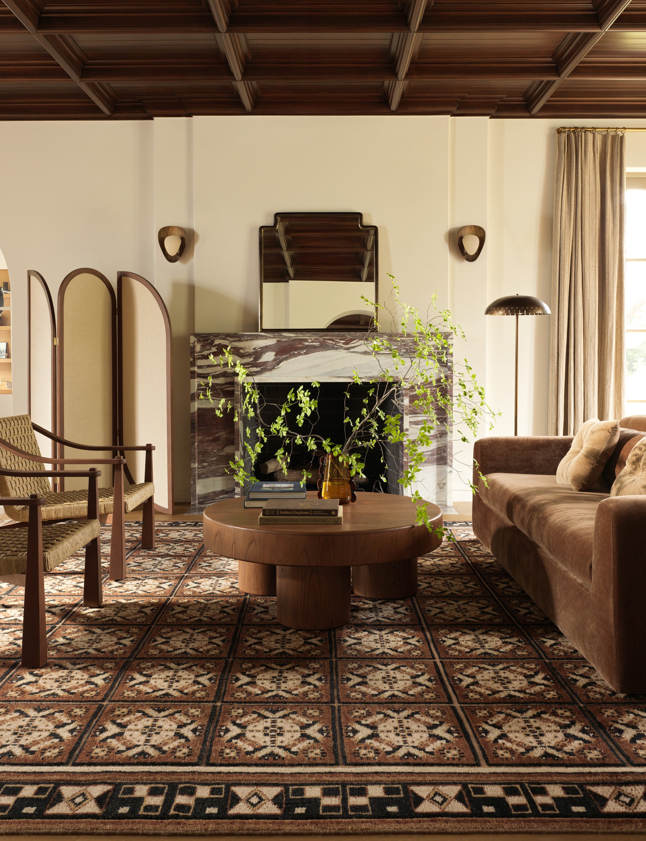 A living room featuring the Ovidi heritage motif hand-knotted wool rug.