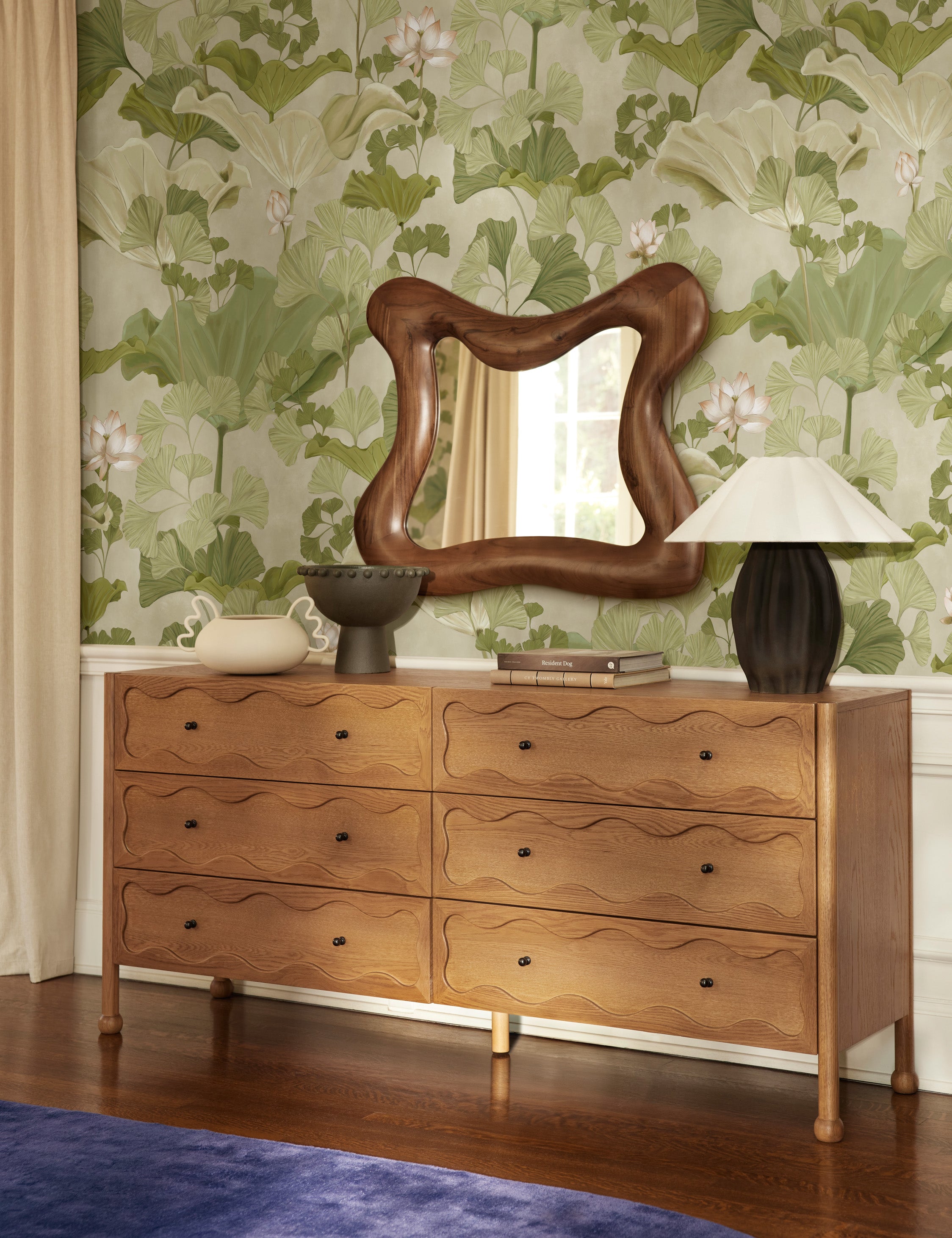 Cambria chunky wood frame wavy silhouette mirror by Aimee Song hung on a wall over a dresser