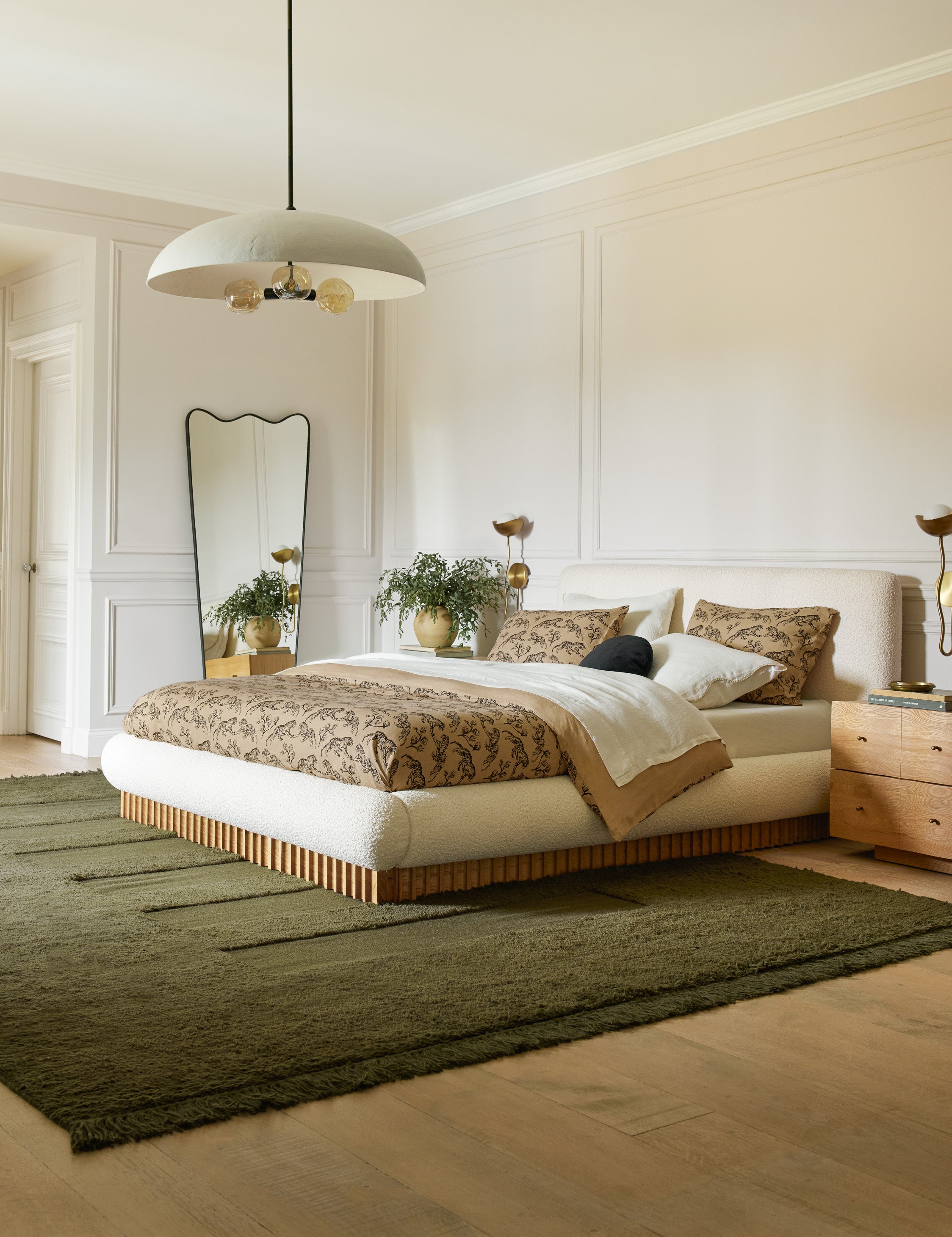 Brolly matte white, 3-bulb dome pendant light in a bedroom hanging over the bed