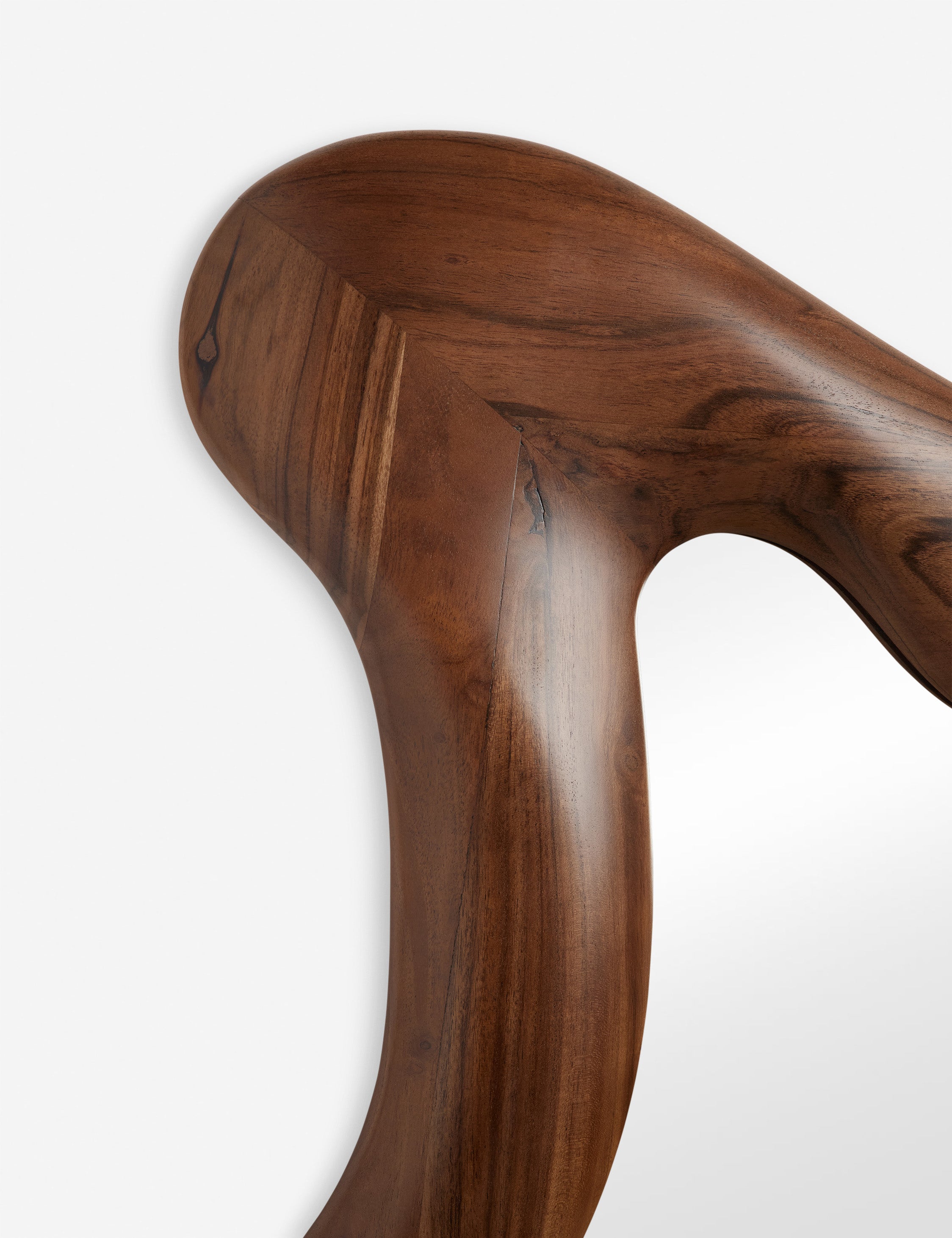 Close up view of the frame of the Cambria chunky wood frame wavy silhouette mirror by Aimee Song