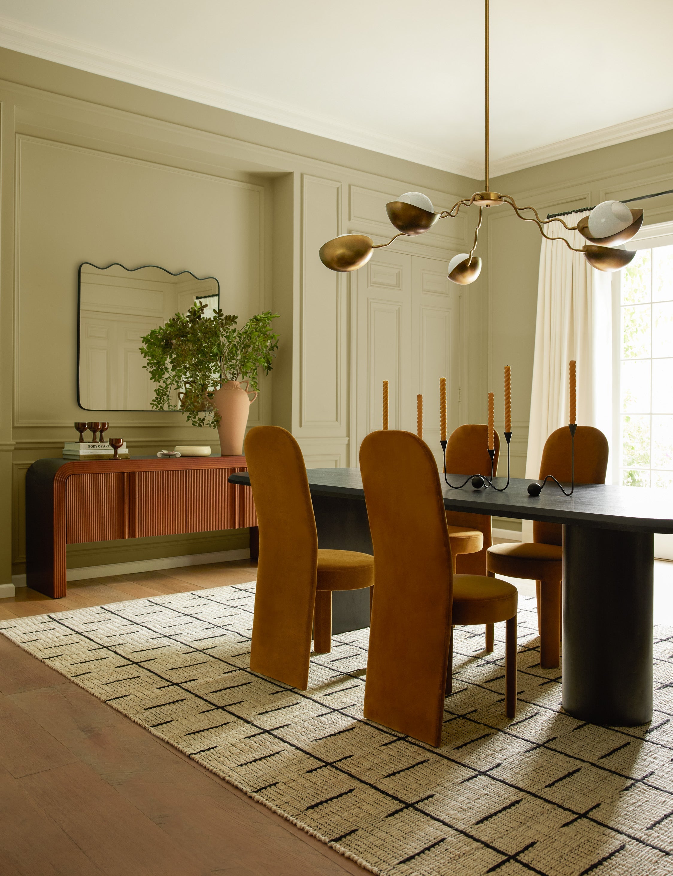 Rook wavy mantel mirror styled above a sideboard in a dining room.