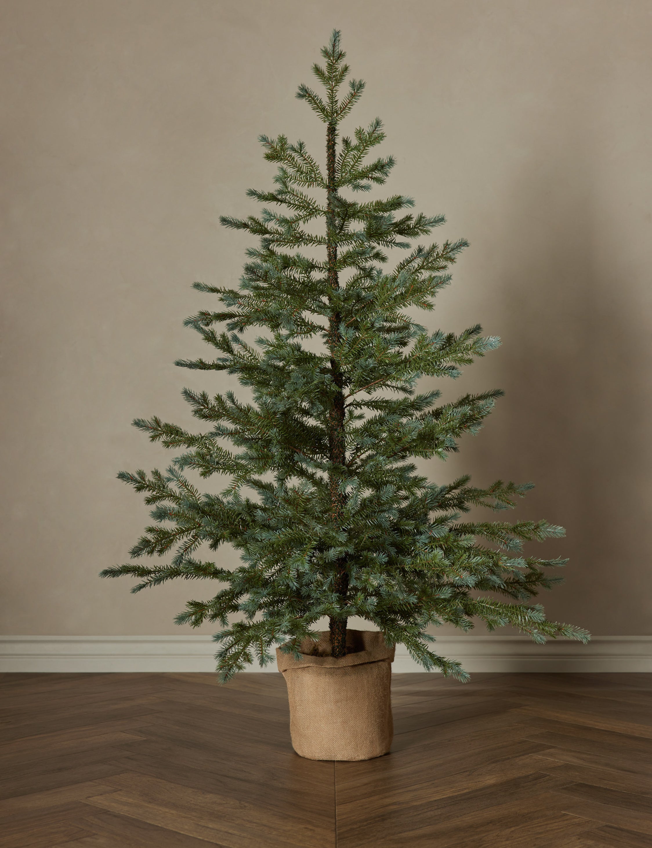 Faux pine tree with burlap sack