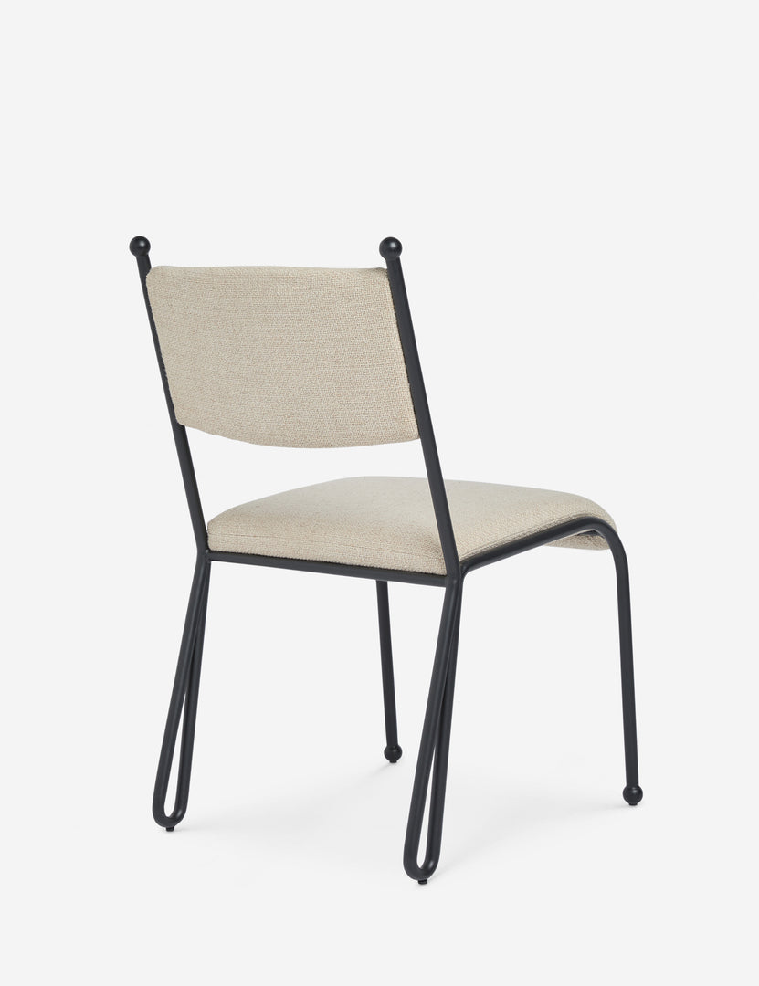 #color::taupe-basketweave | Angled back view of the Fidia curved metal silhouette dining chair by Aimee Song