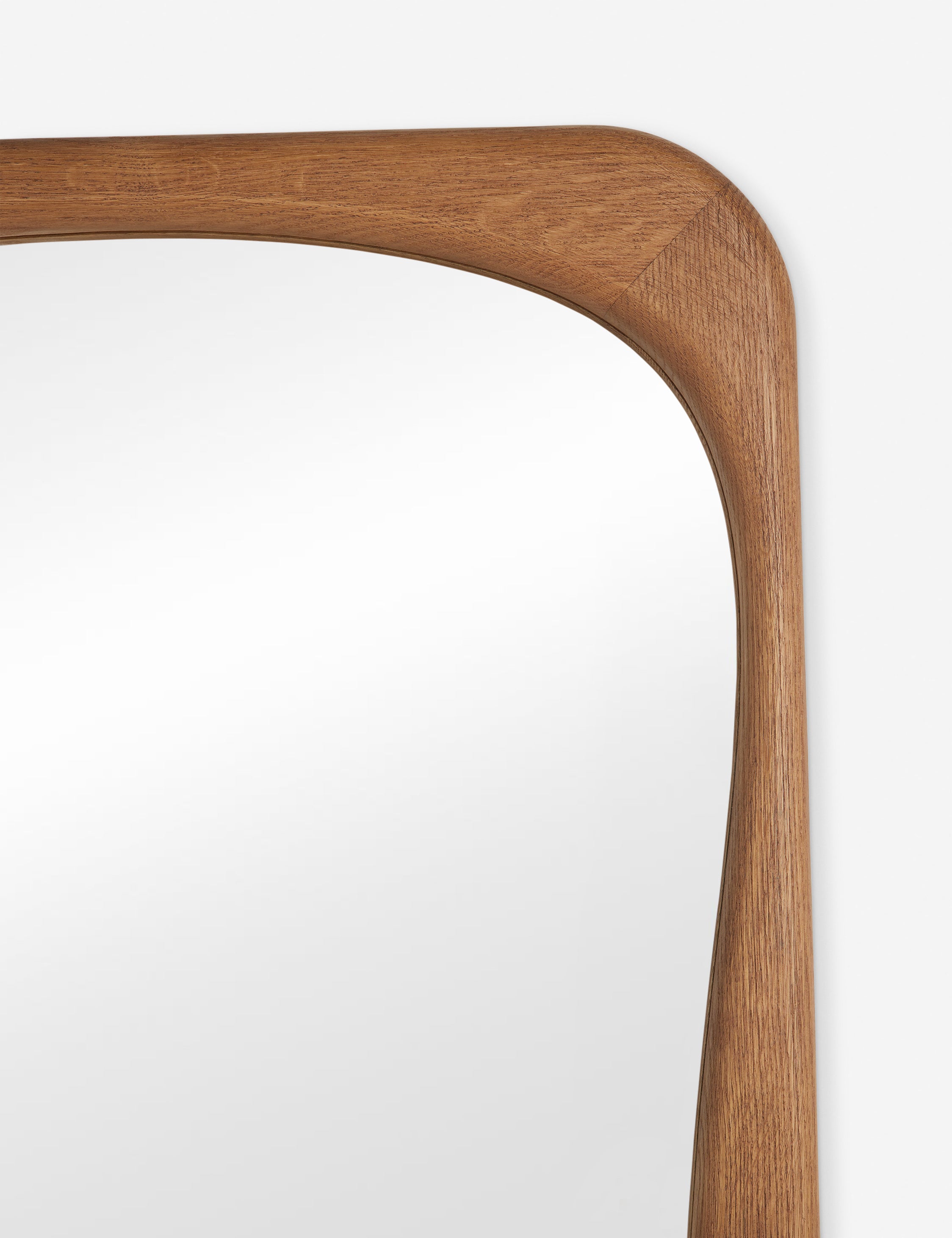 Close up view of the frame of the Galilea solid wavy wood frame floor mirror mirror by Aimee Song