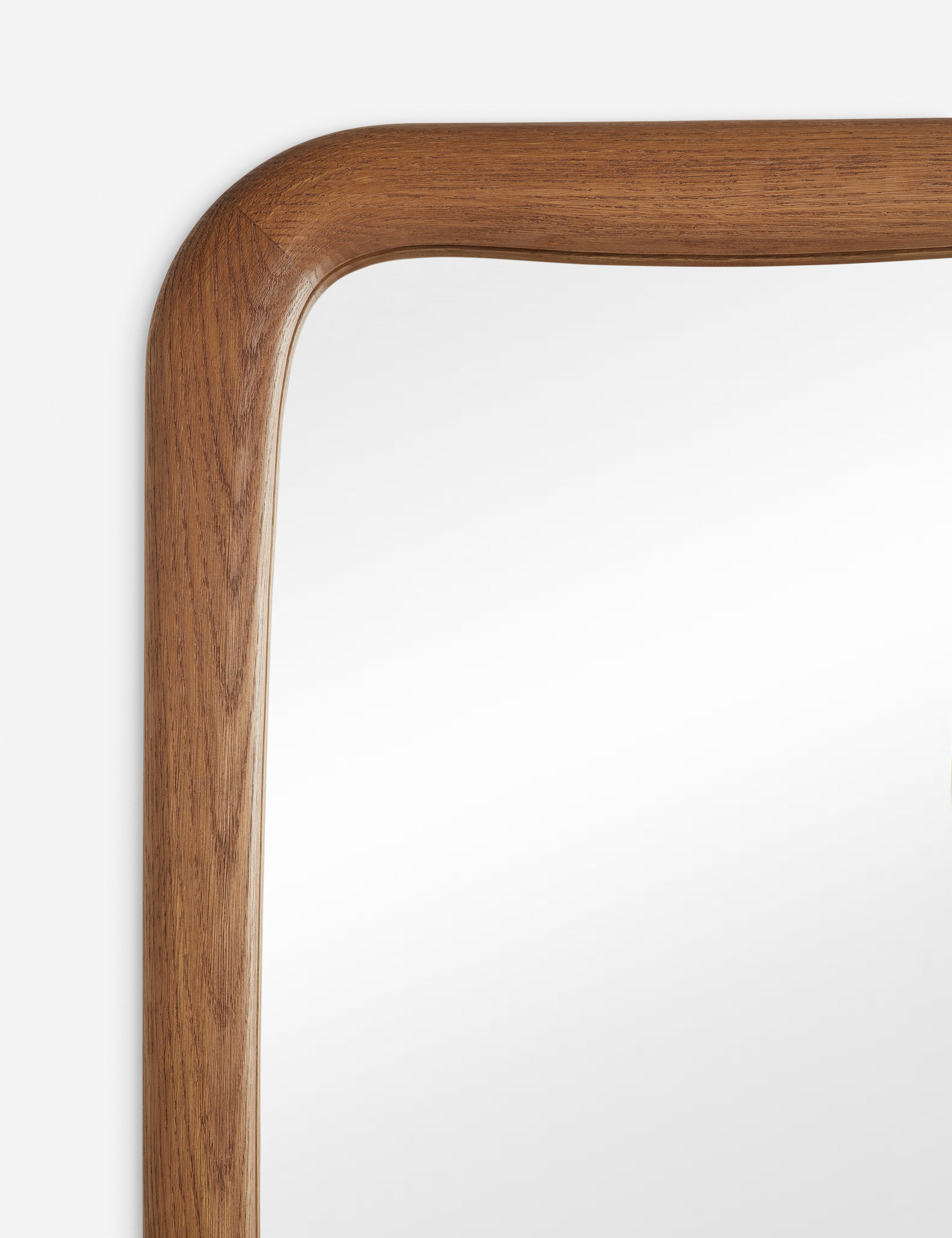 Close up view of the frame of the Galilea solid wavy wood frame floor mirror mirror by Aimee Song