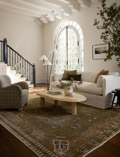 #color::natural | Living room featuring a white sofa, grid print upholstered accent chair and Rodolfo organic oval natural wood coffee table