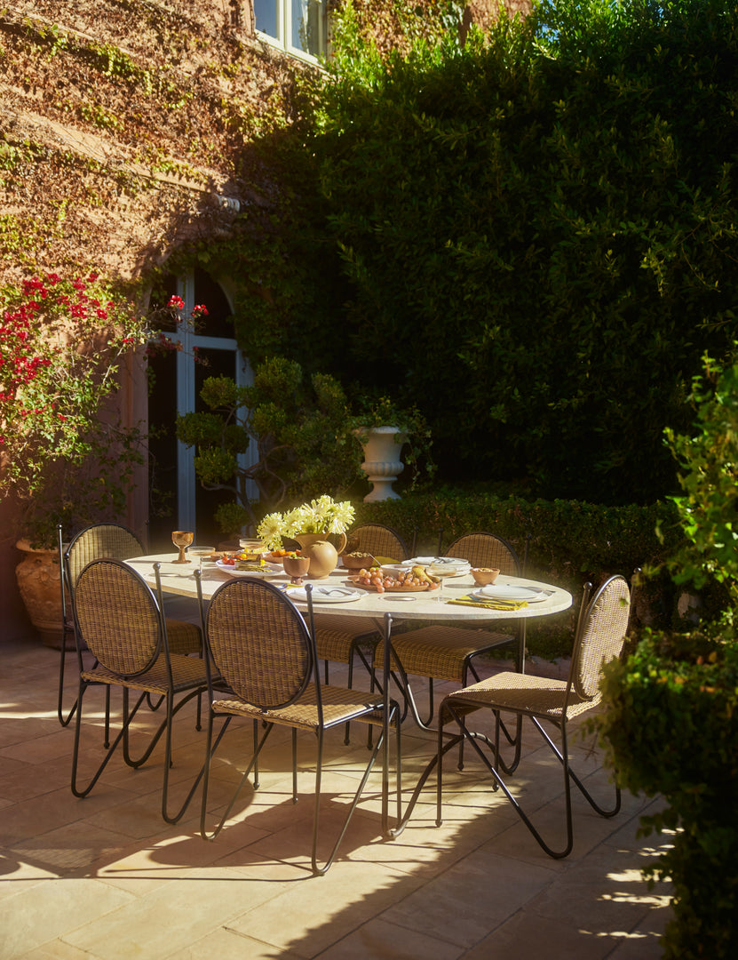 #color::natural | Six Ziggy modern wicker outdoor dining chair by Sarah Sherman Samuel placed around an oval outdoor dining table.
