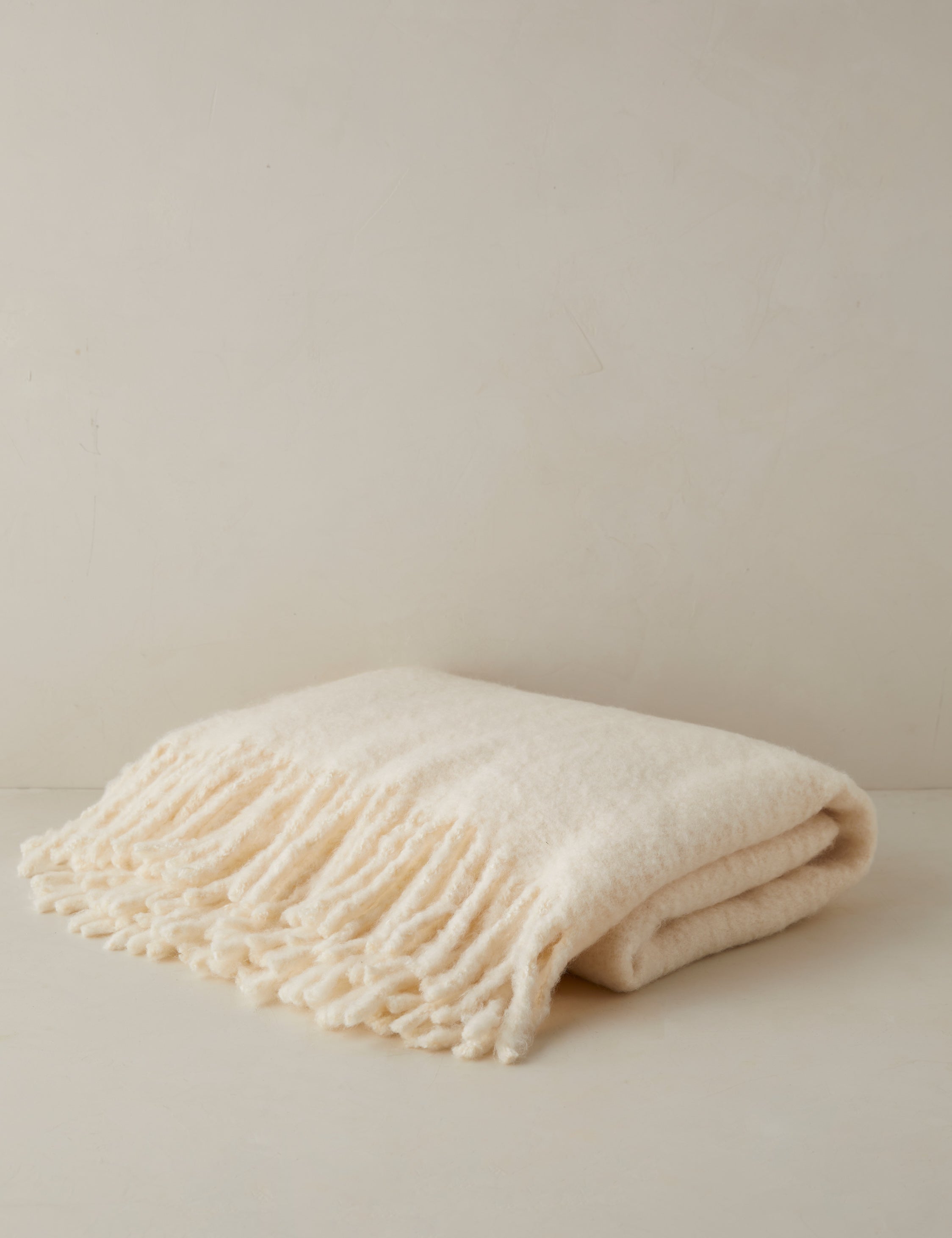 Snug faux mohair throw blanket in cream