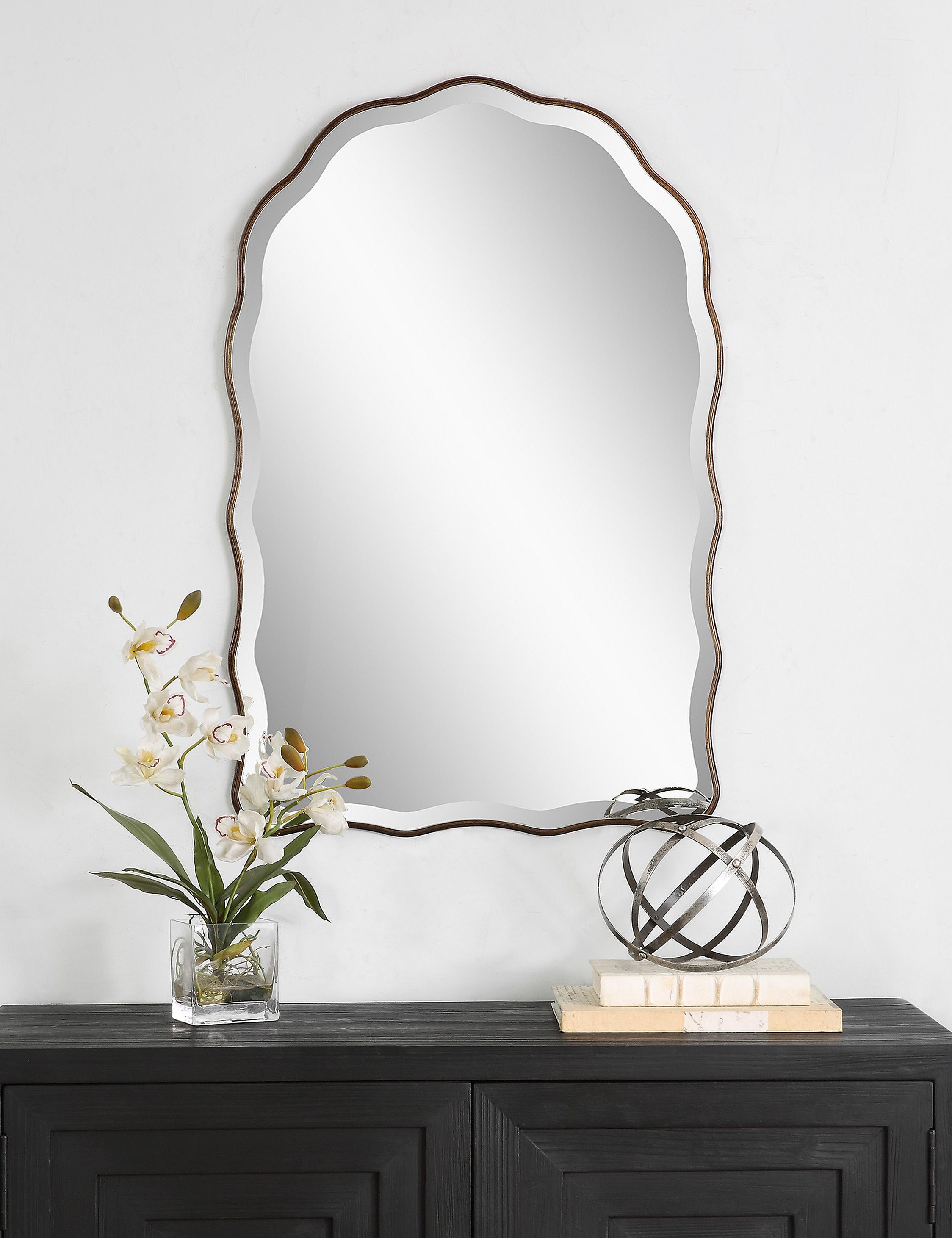 Gannet scalloped frame wall mirror hanging above a console table