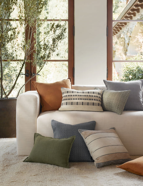 #color::dusty-blue #color::burnt-orange #color::olive #fill type::with-feather-down-insert #fill type::pillow-cover-only | The dusty blue, burnt orange, and olive arlo linen pillows sit together on a plush ivory rug and a natural linen sofa