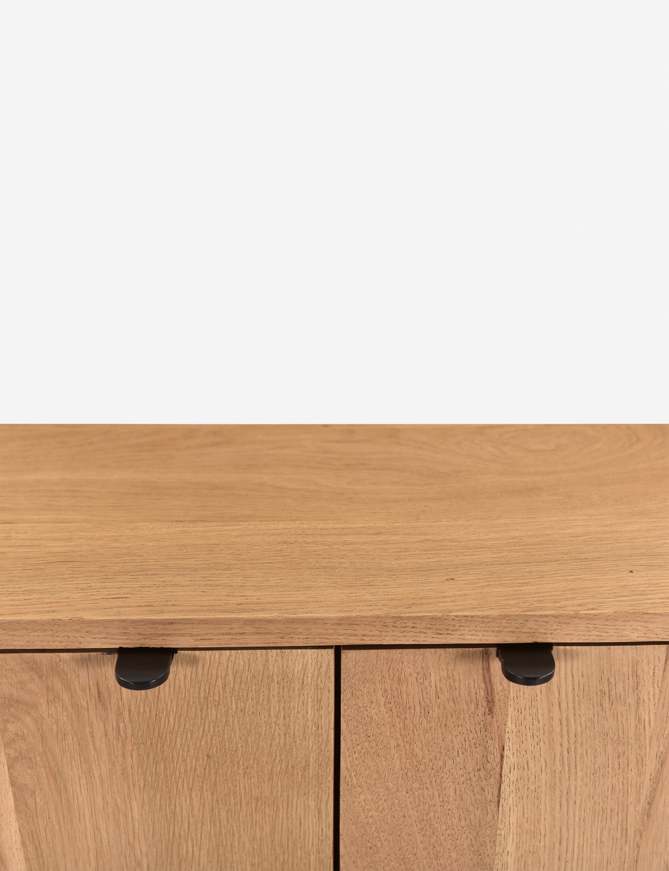 Close up of the handles of the Kono 2-door curved oak cabinet.