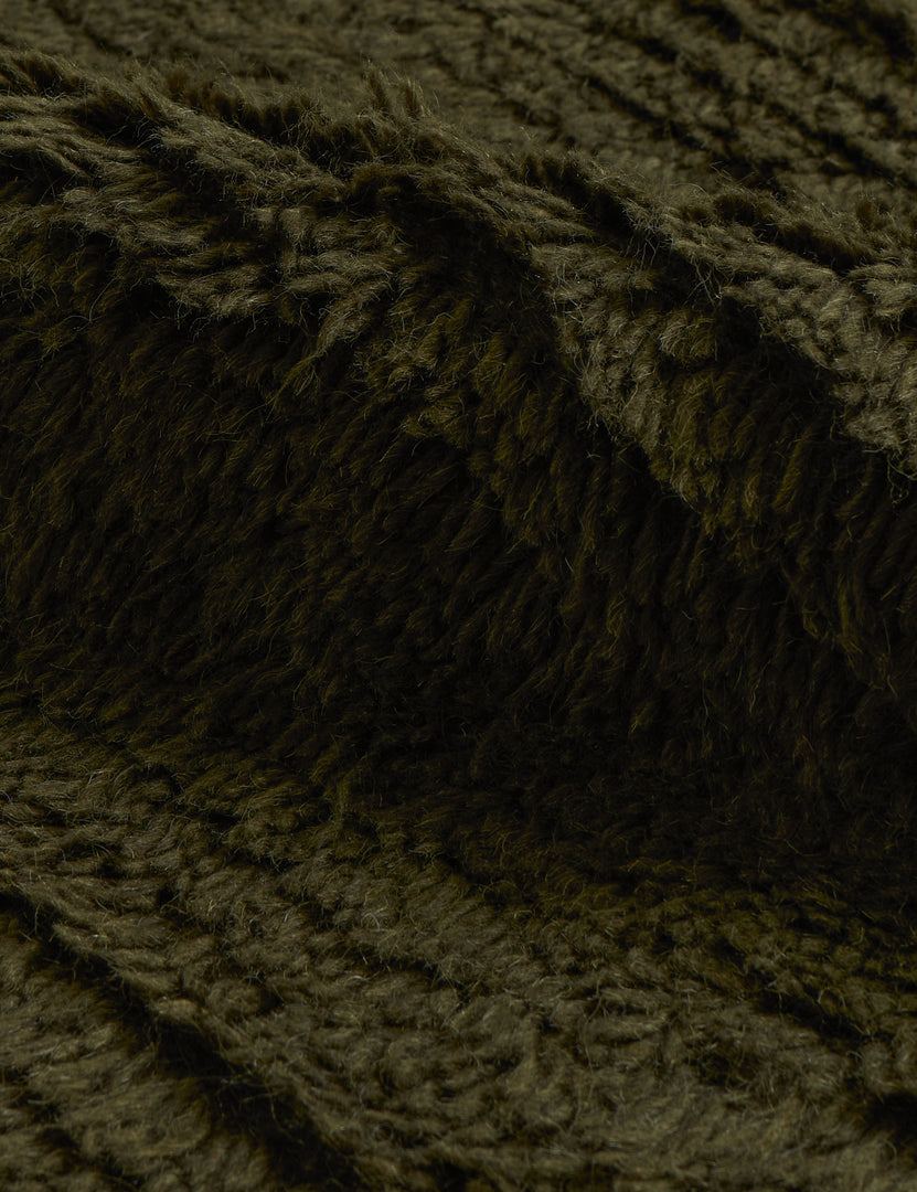 #color::moss #size::6--x-9- #size::8--x-10- #size::9--x-12- #size::10--x-14- #size::12--x-15- | Close up of the Raita subtle bar patter fringe area rug in moss green
