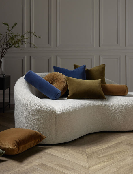 #color::true-blue #style::square  #fill type::with-feather-down-insert  #fill type::pillow-cover-only |   Charlotte velvet pillow in toast, olive, and true blue sit on a cream boucle lounger with other velvet pillows