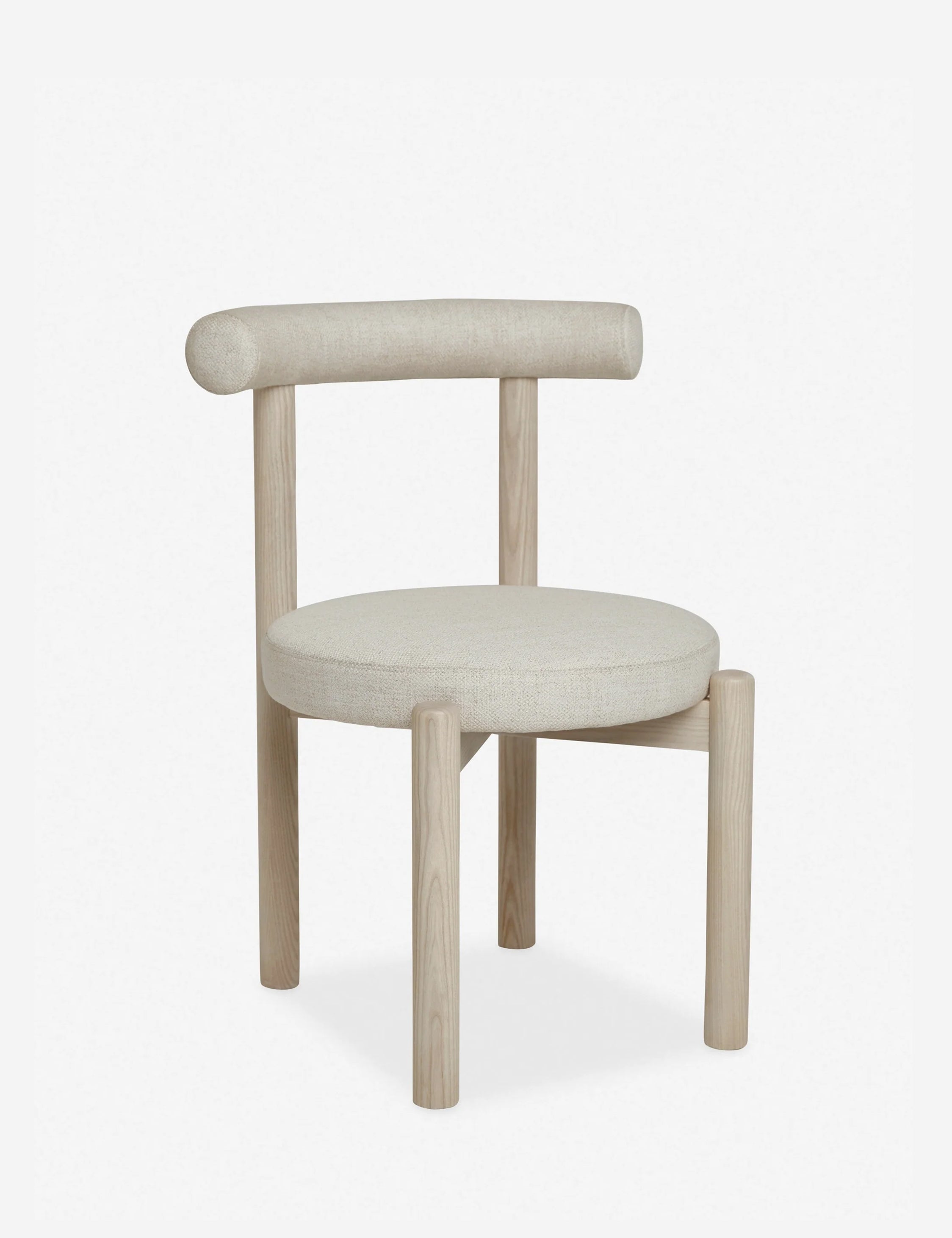 Angled left view of the Dame minimalist rounded open-back dining chair with ivory upholstered seat and ash wood frame