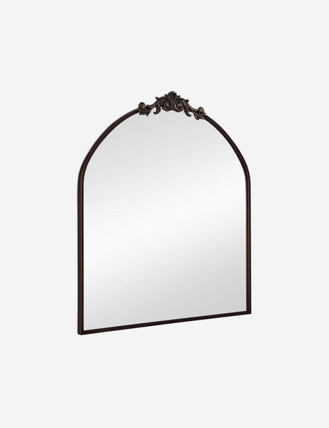#color::oil-rubbed-bronze | Angled view of the Tulca arched oil rubbed bronze mirror with flat bottom edge and traditional scroll detailing.