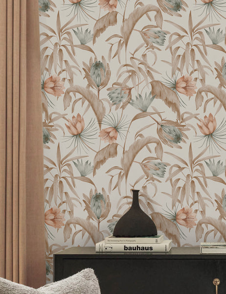 #color::natural | Natural-toned Tropical Wallpaper by Rylee + Cru is in a room with light brown curtains and a black side table with a black vase atop it