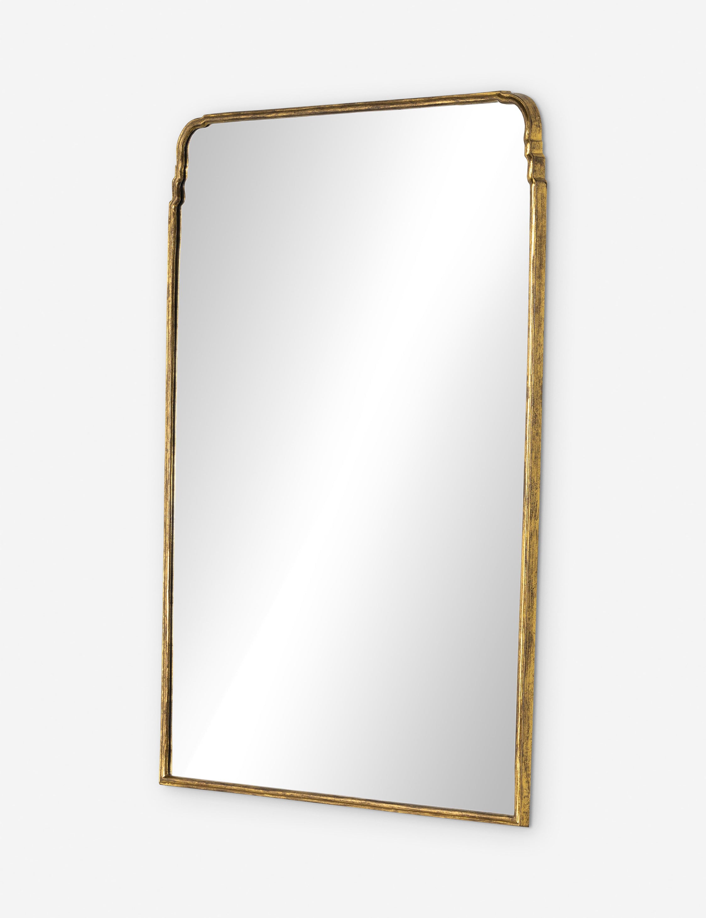 Angled view of the Teresa thin gold-leaf frame floor mirror.