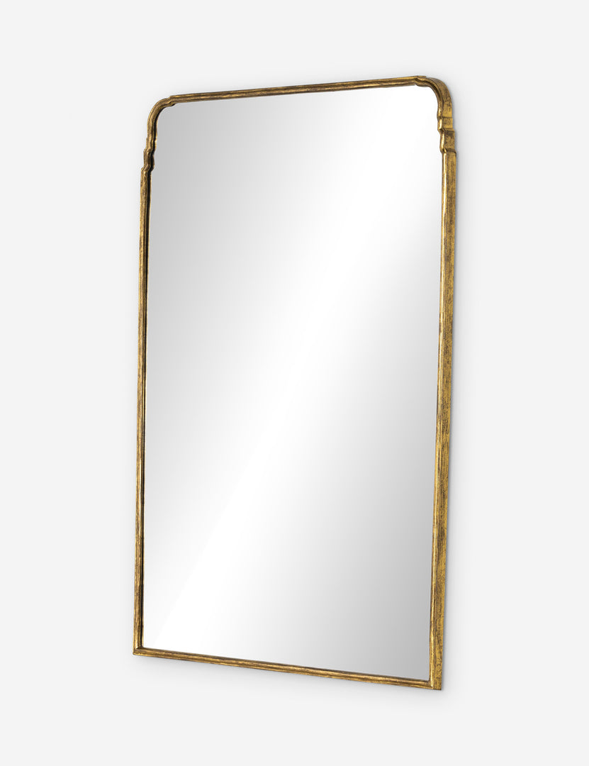 | Angled view of the Teresa thin gold-leaf frame floor mirror.