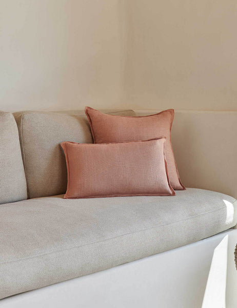 #color::terracotta #style::square #fill type::with-feather-down-insert #fill type::pillow-cover-only | The arlo Terracotta flax linen pillow in its lumber and square sizes sit together on a natural linen sofa