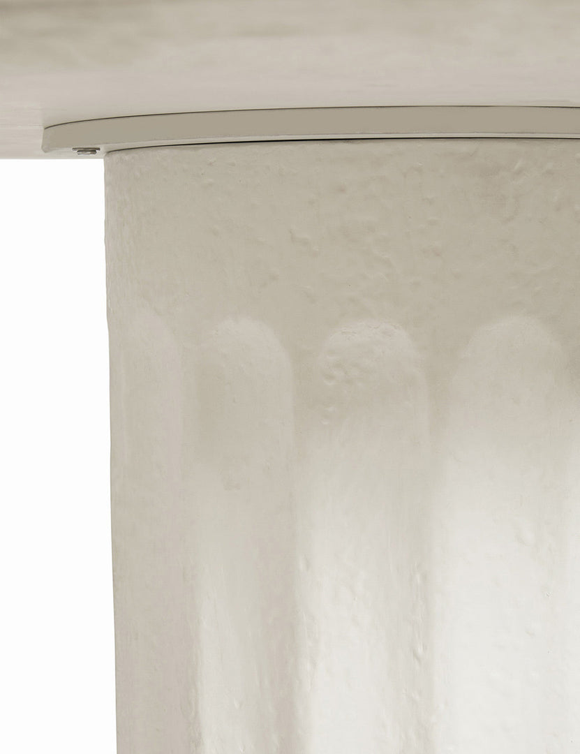 | The underside of the Doric white round dining table where the column base and top connect