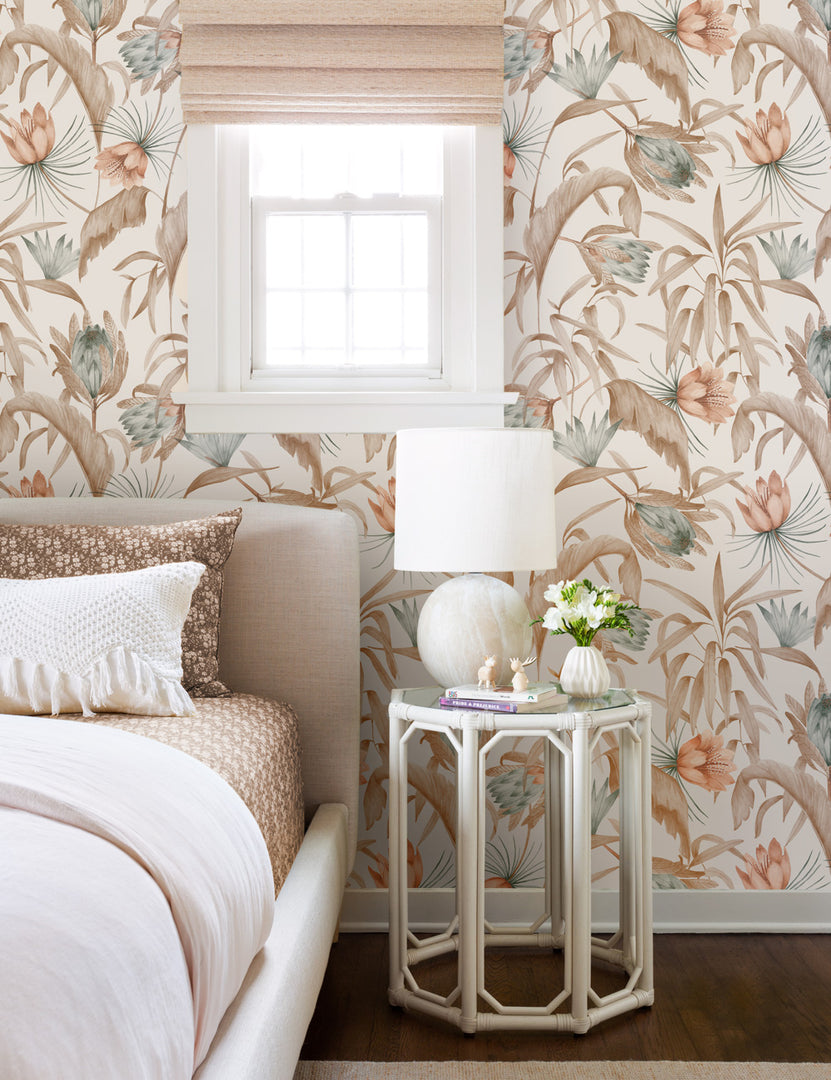 #color::natural | Natural-toned Tropical Wallpaper by Rylee + Cru is in a bedroom with a linen framed bed and a glass hexagonal nightstand