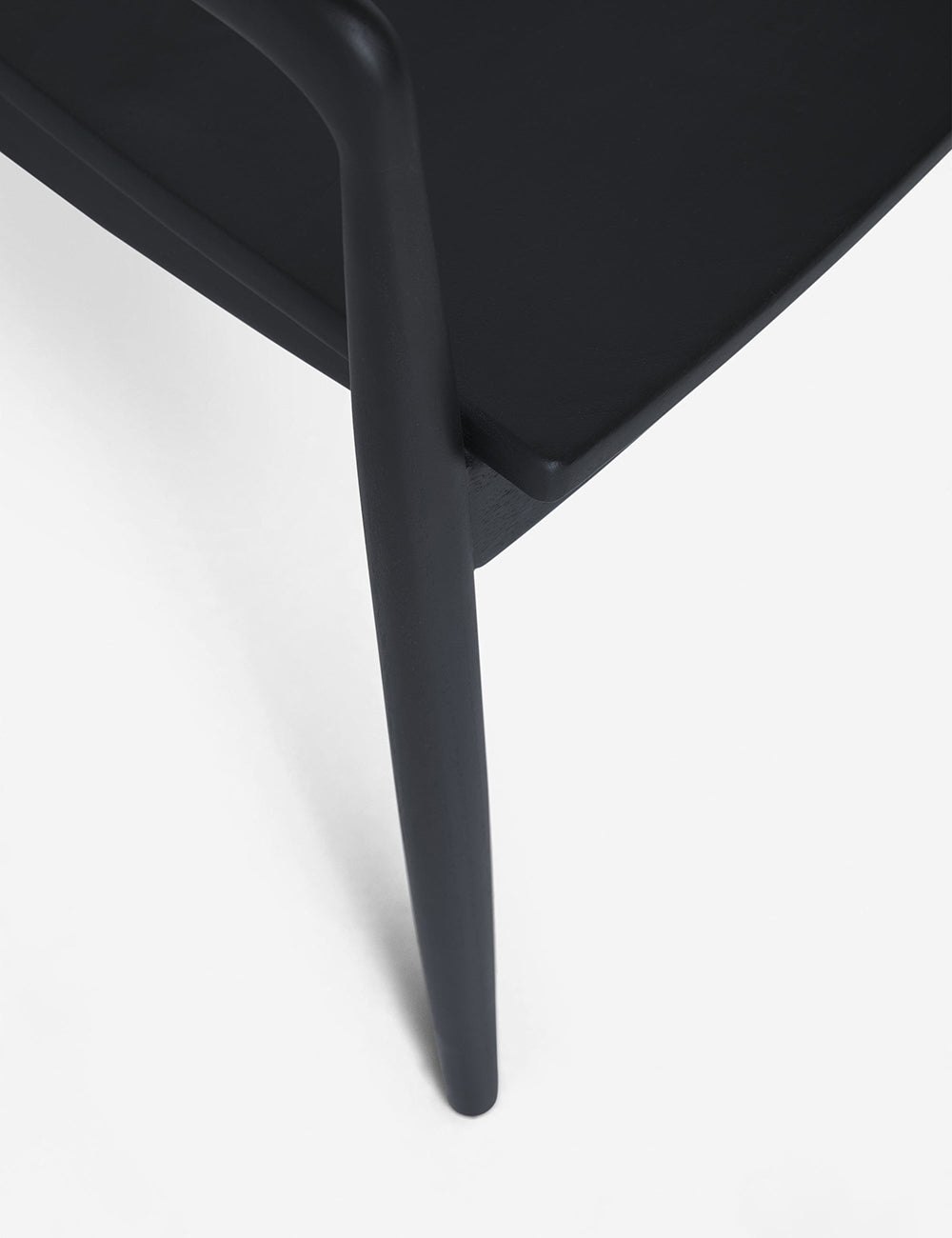 The leg and seat of the Ida Black Dining Arm Chair