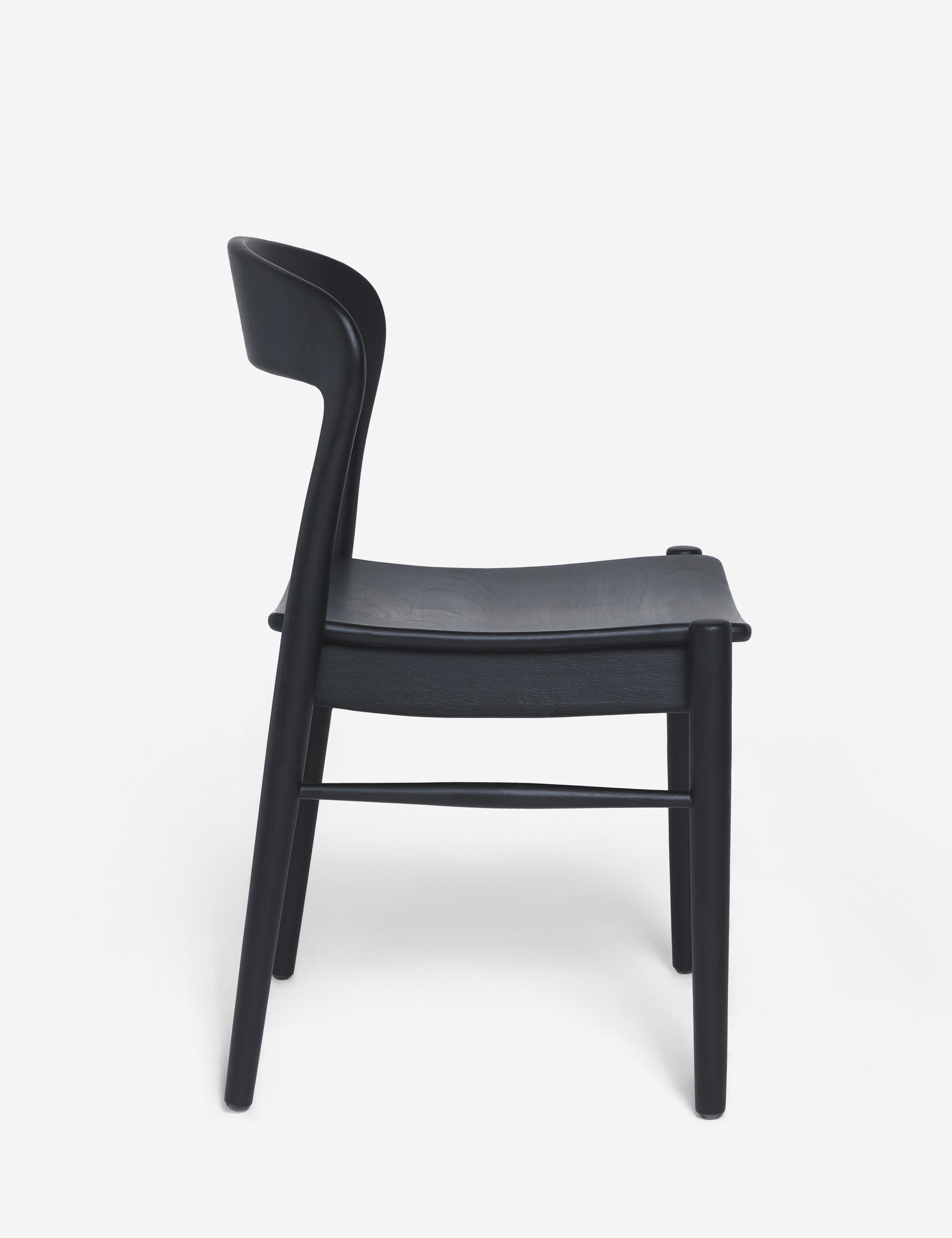 Side view of the Ida black teak wood dining chair.