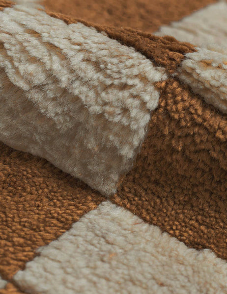 #color::ochre #size::2-6--x-8- #size::6--x-9- #size::8--x-10- #size::9--x-12- #size::10--x-14- #size::12--x-15- | Detailed view of the high-low pile fiber and texture on the Irregular ochre checkerboard rug by Sarah Sherman Samuel