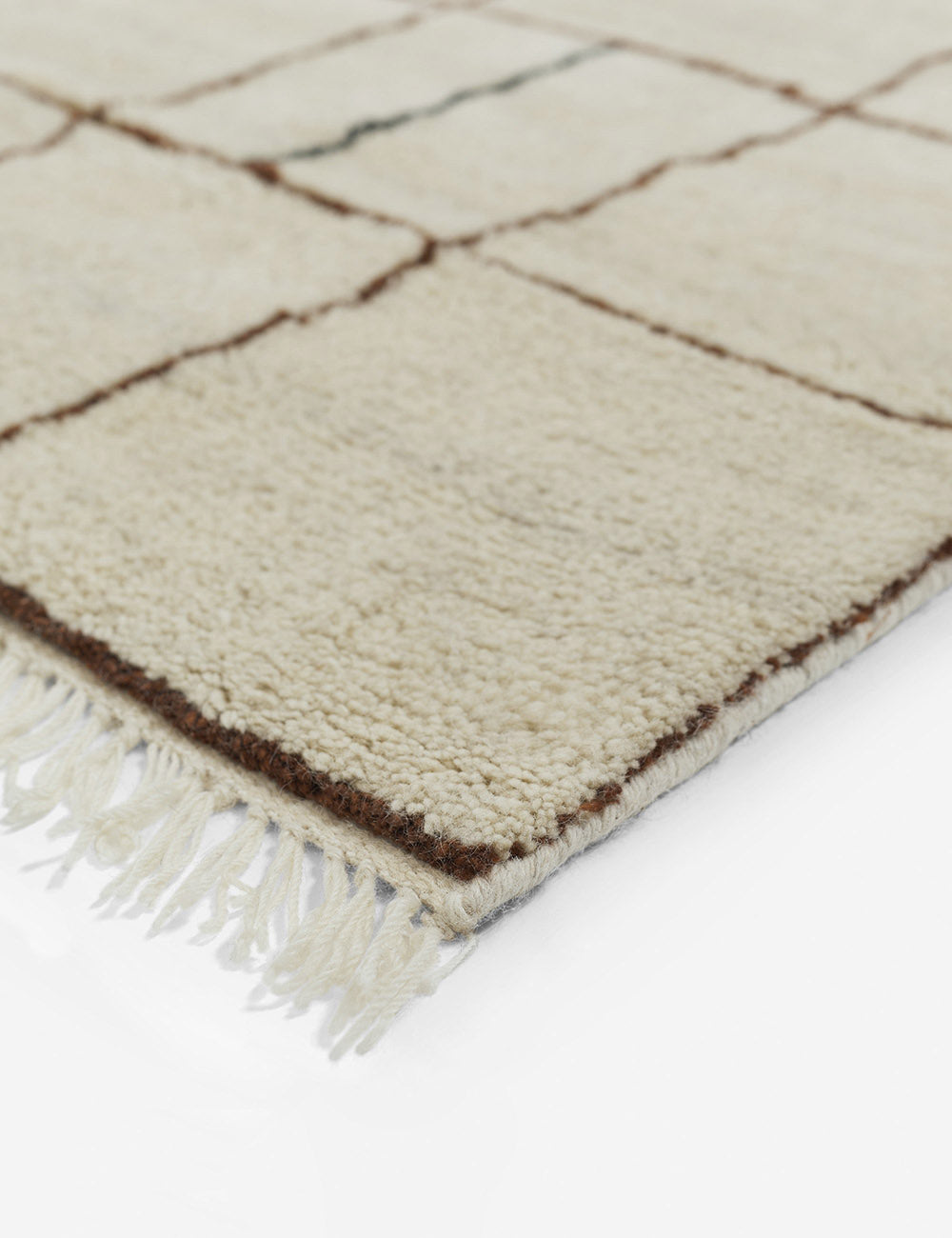 Tasseled ends on the corner of the Irregular Grid Rug by Sarah Sherman Samuel