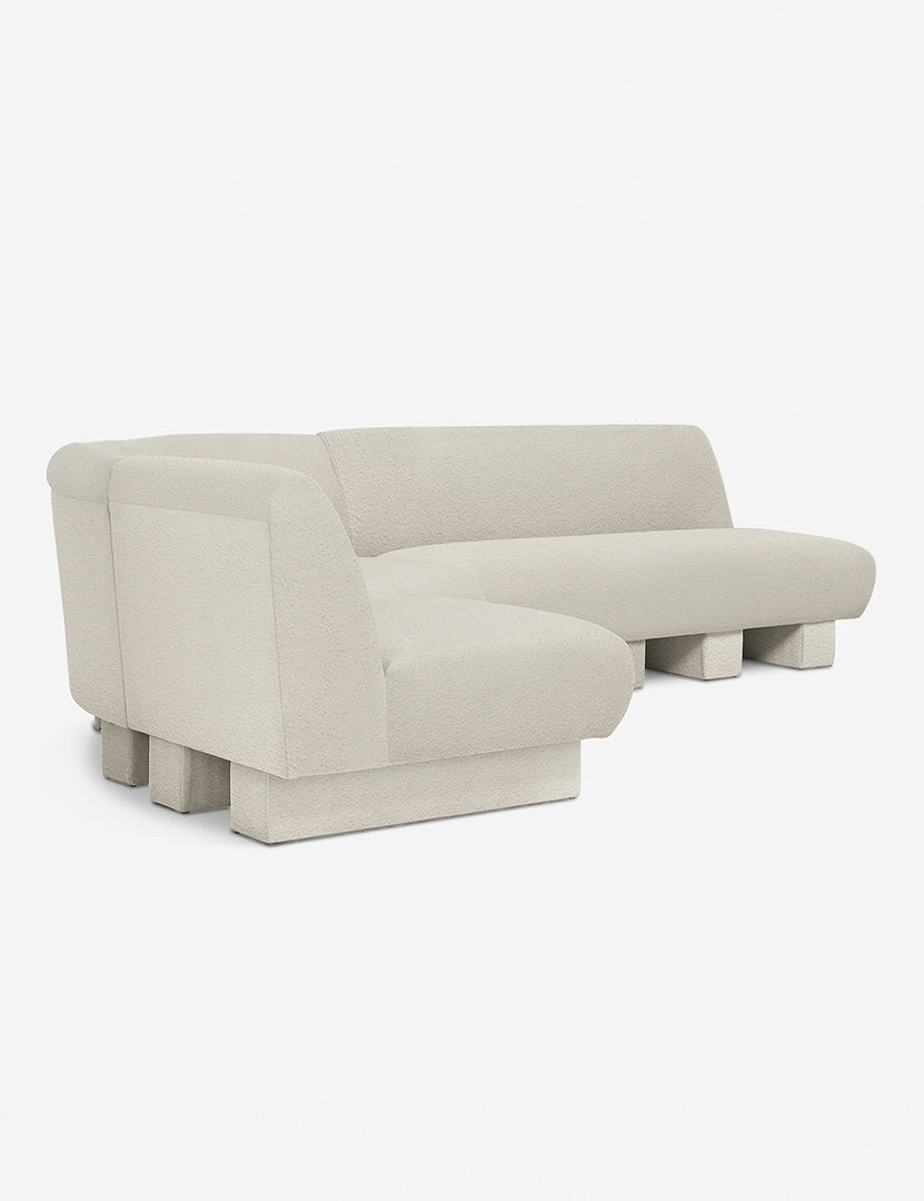 #color::Ivory-Boucle #configuration::left-facing #size::114-W | Angled view of the Lena left-facing white boucle sectional sofa with upholstered beam legs.
