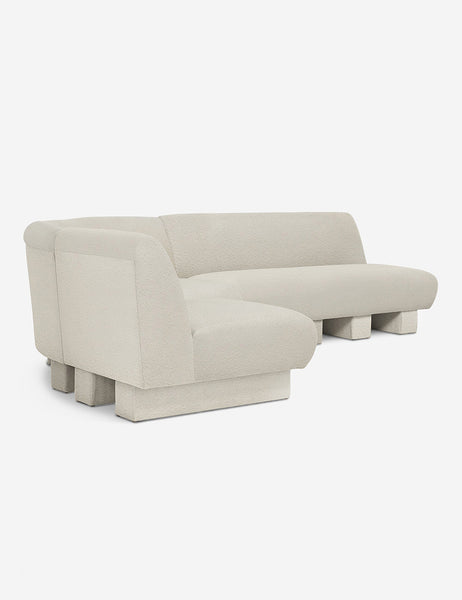 #color::Ivory-Boucle #configuration::left-facing #size::114-W | Angled view of the Lena left-facing white boucle sectional sofa with upholstered beam legs.