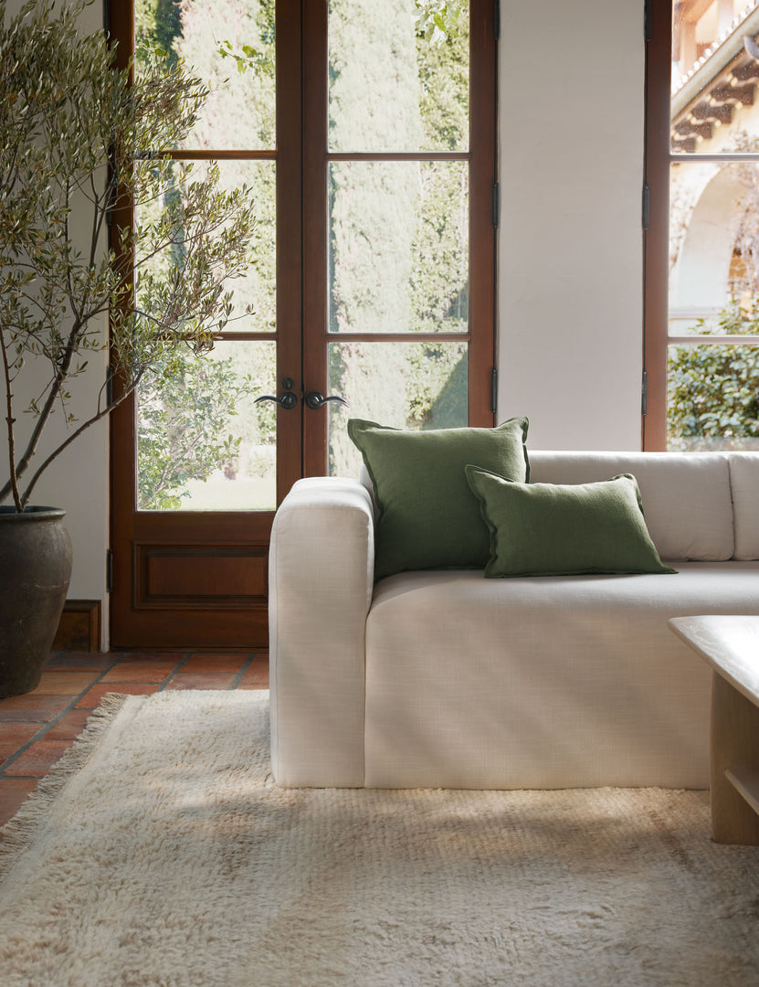 #color::olive #style::square #fill type::with-feather-down-insert #fill type::pillow-cover-only | The arlo Olive green flax linen pillow in its lumber and square sizes sit together on a natural linen sofa