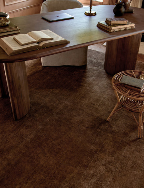 #color::copper #size::6--x-9- #size::8--x-10- #size::9--x-12- #size::10--x-14- #size::12--x-15- #size::6--round #size::8--round | The Chiltern copper rug lays in an office space with wooden accented walls under a dark wooden desk