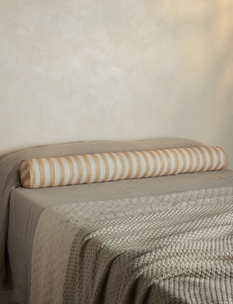 #color::natural-and-ivory | Painterly stripe linen long bolster throw pillow in natural and ivory styled on a bed