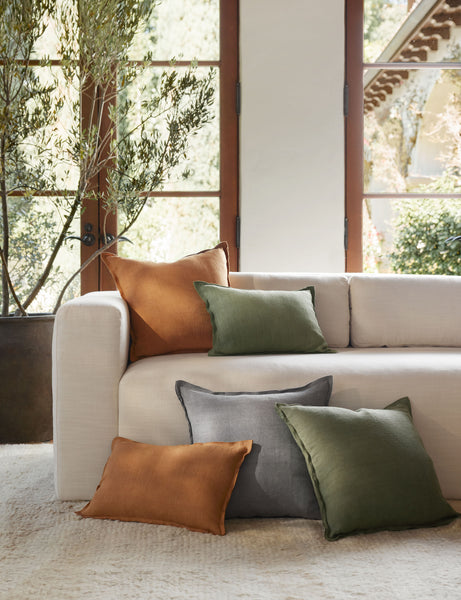 #color::dusty-blue #color::burnt-orange  #color::olive #fill type::with-feather-down-insert #fill type::pillow-cover-only | The dusty blue, burnt orange, and olive arlo linen pillows sit together on a plush ivory rug and a natural linen sofa