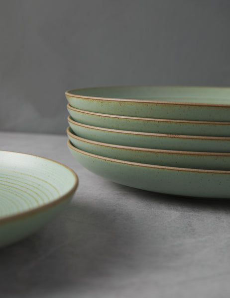 #color::leaf | Close-up of the brown rims around the set of six leaf green stoneware nature dinner plates by thomas for rosenthal
